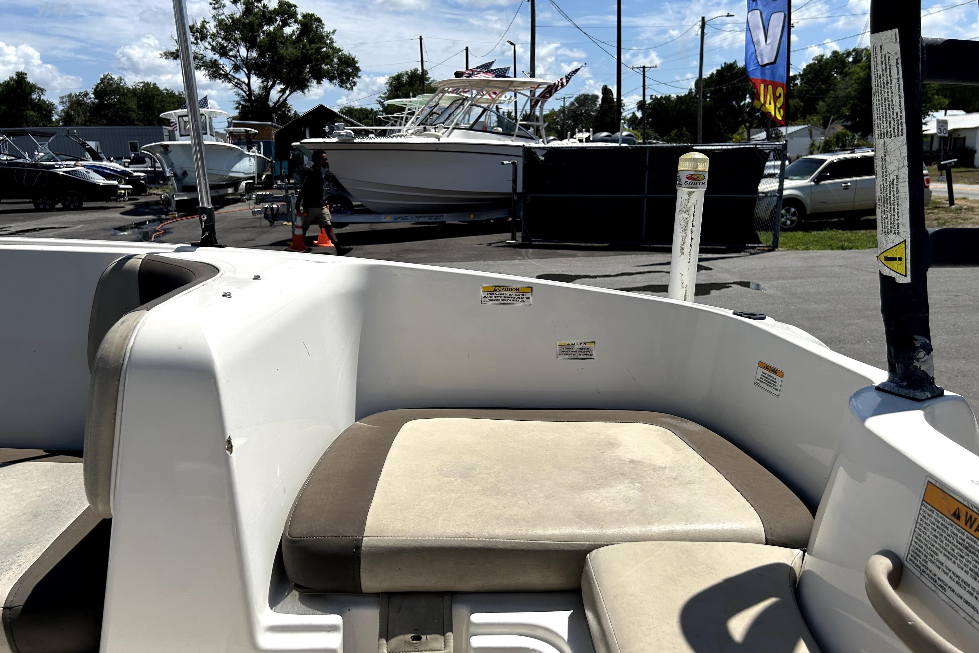 2017 Bayliner Element E16 boat interior with seating, parked in a marina.