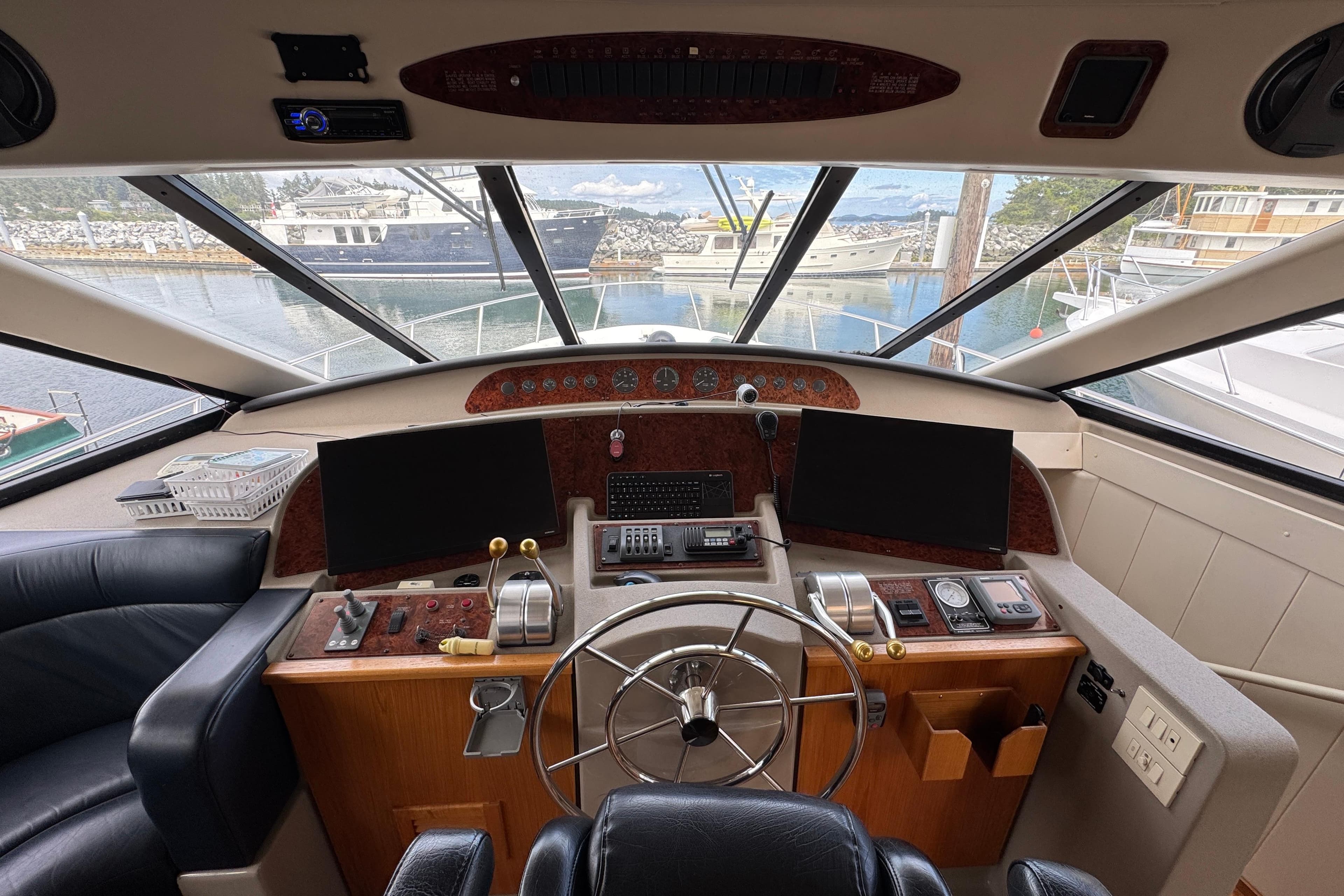1998 Bayliner 5788 Pilot House Motoryacht helm with steering wheel and navigation controls.