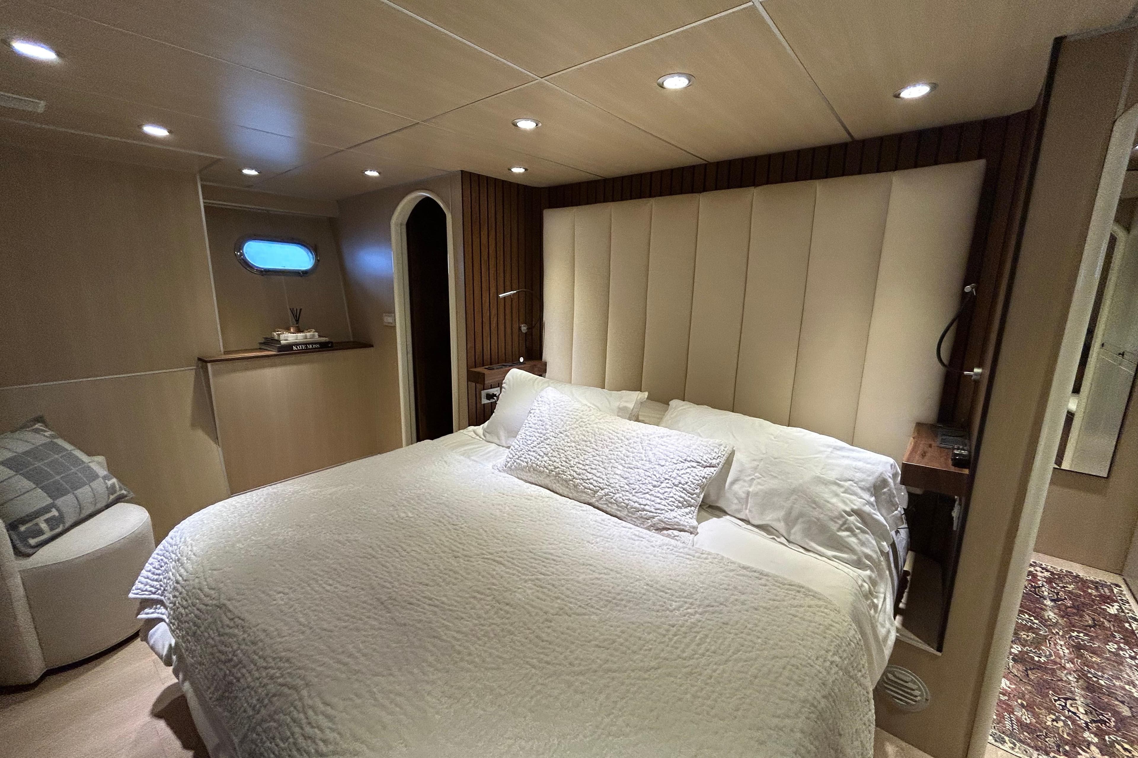 Luxurious bedroom interior of 2002 Cheoy Lee 66 Pilothouse yacht with elegant lighting.