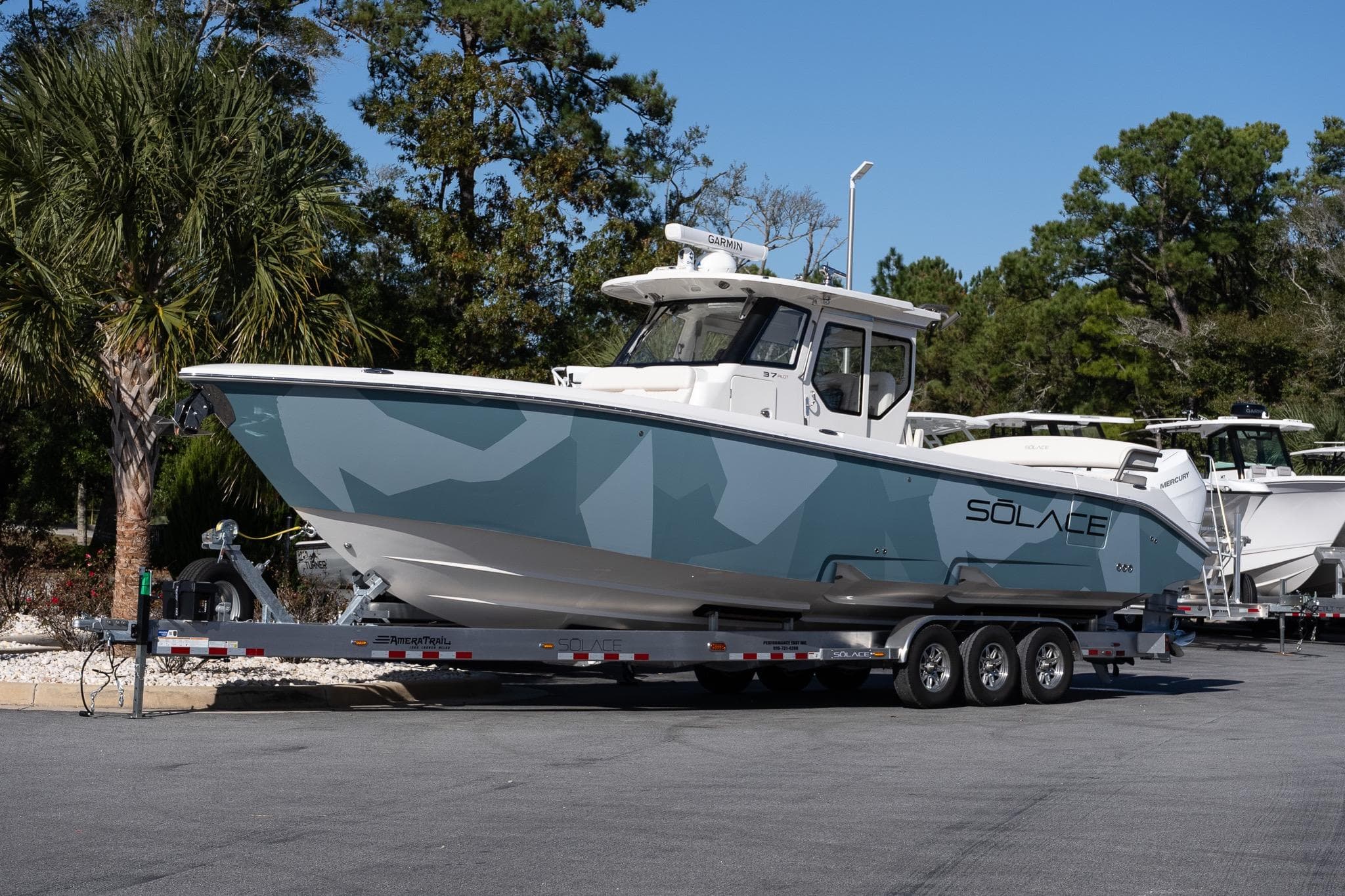 2026 Solace 37 Pilot boat on trailer, parked outdoors with trees in background.