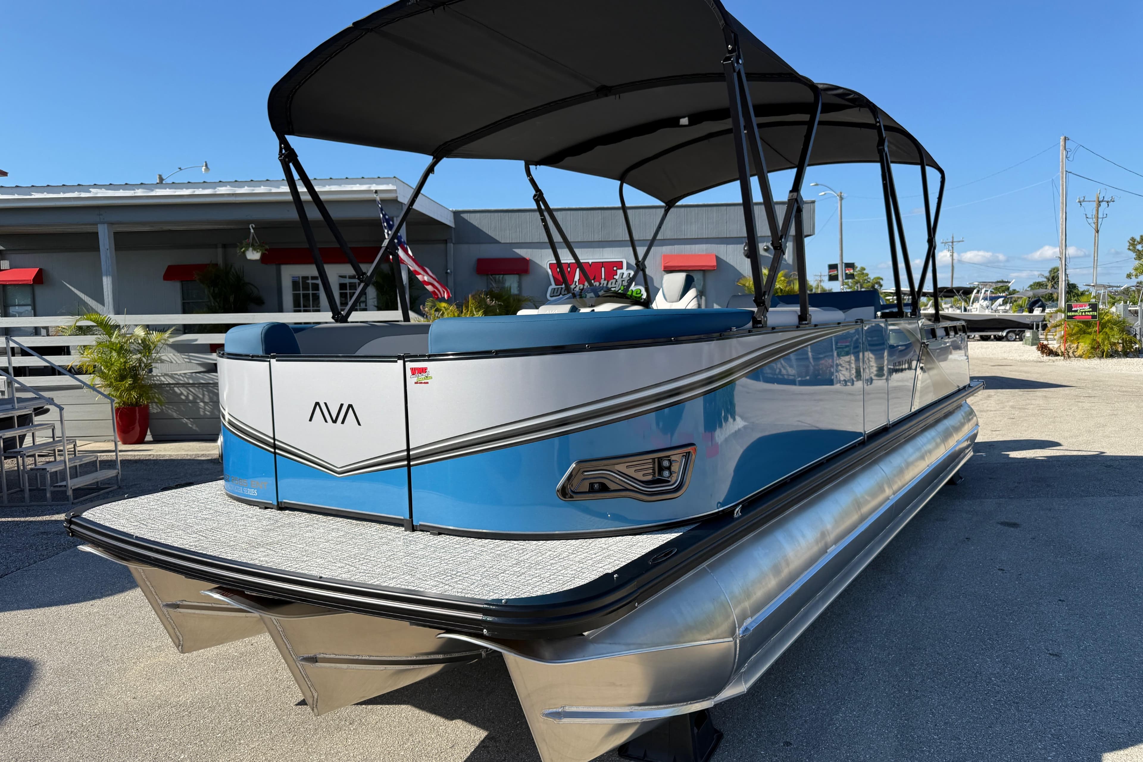 2026 Avalon 2585 LSZ Entertainer Tri Toon boat with canopy, parked outdoors.