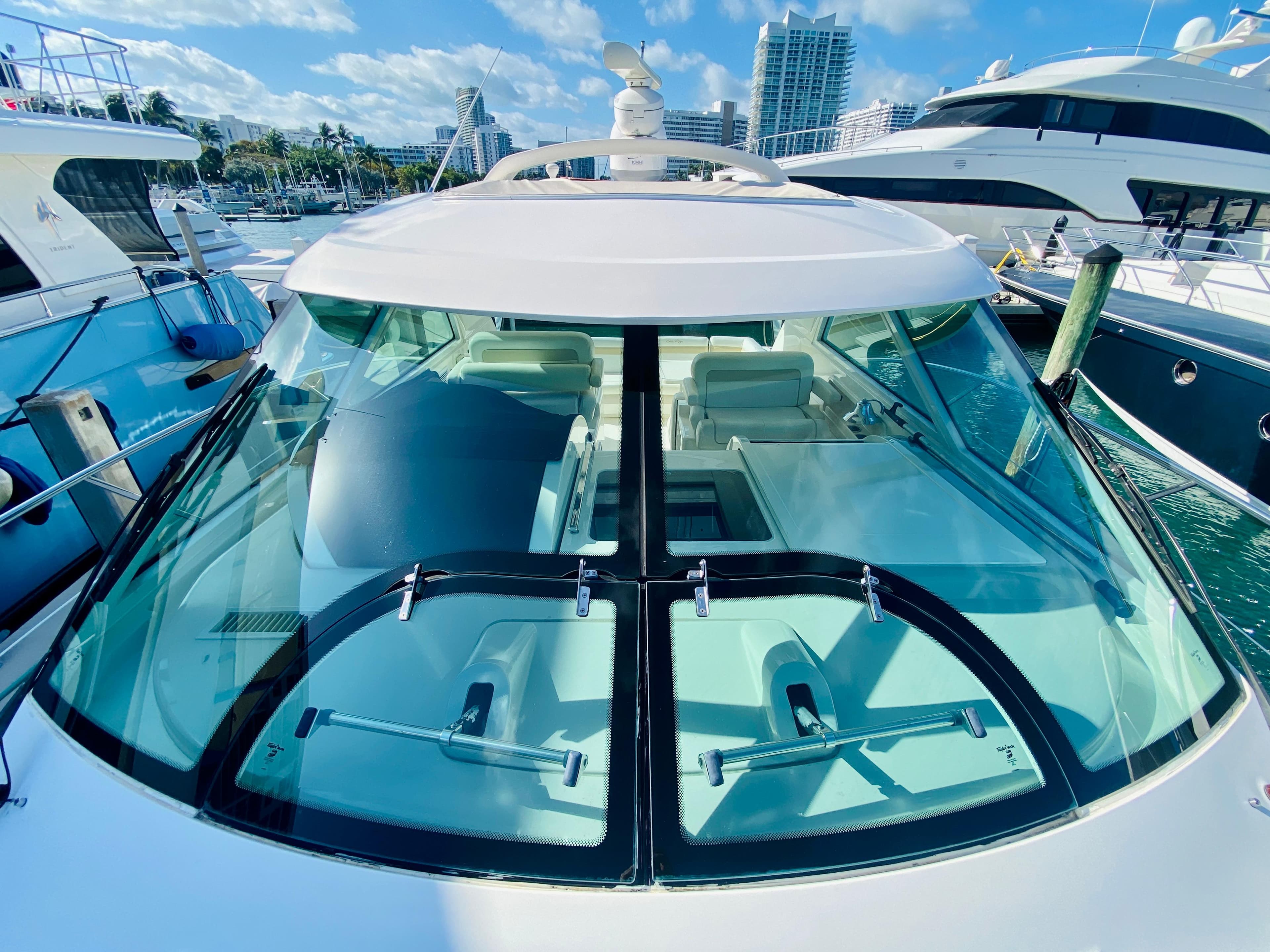 2010 Sea Ray 450 Sundancer yacht docked at marina with clear blue skies.