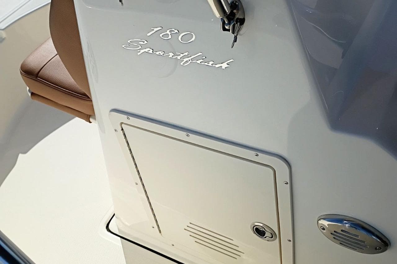 2026 Pioneer 180 Sportfish boat console with storage compartment and seating.