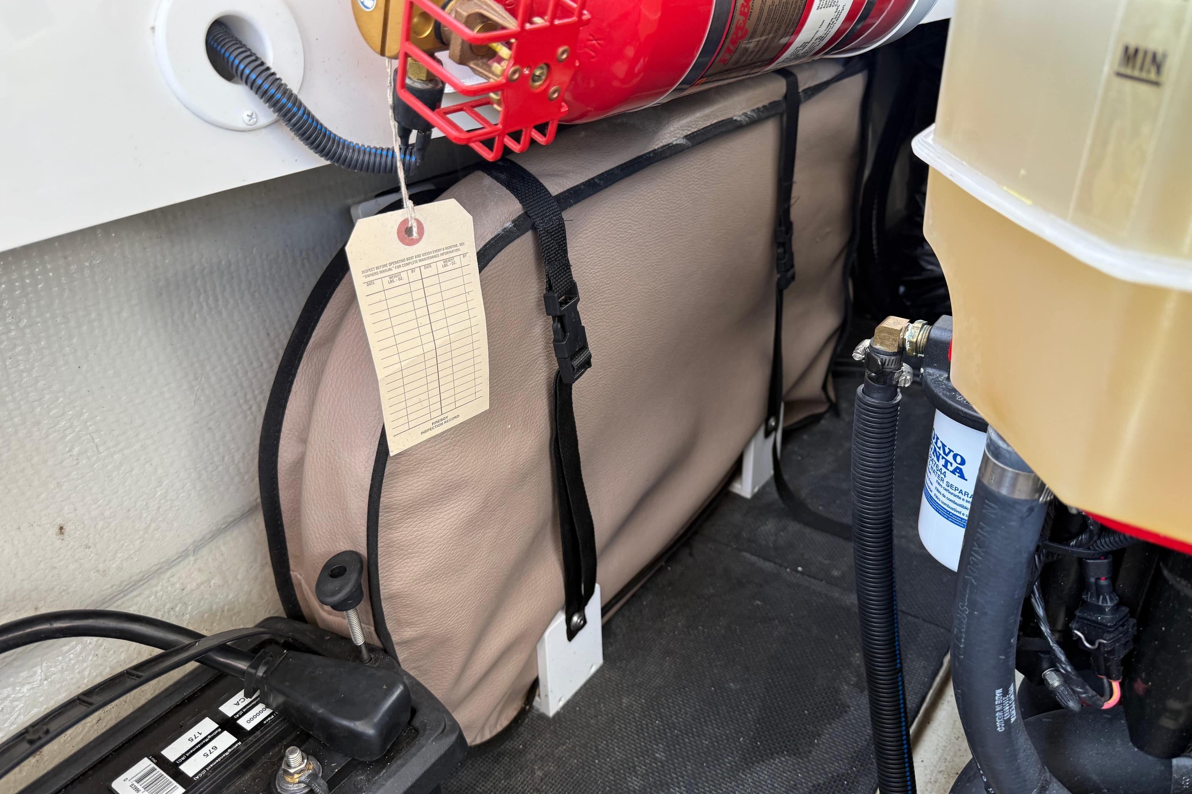 2017 Cobalt R30 engine compartment with fire extinguisher and maintenance tag.