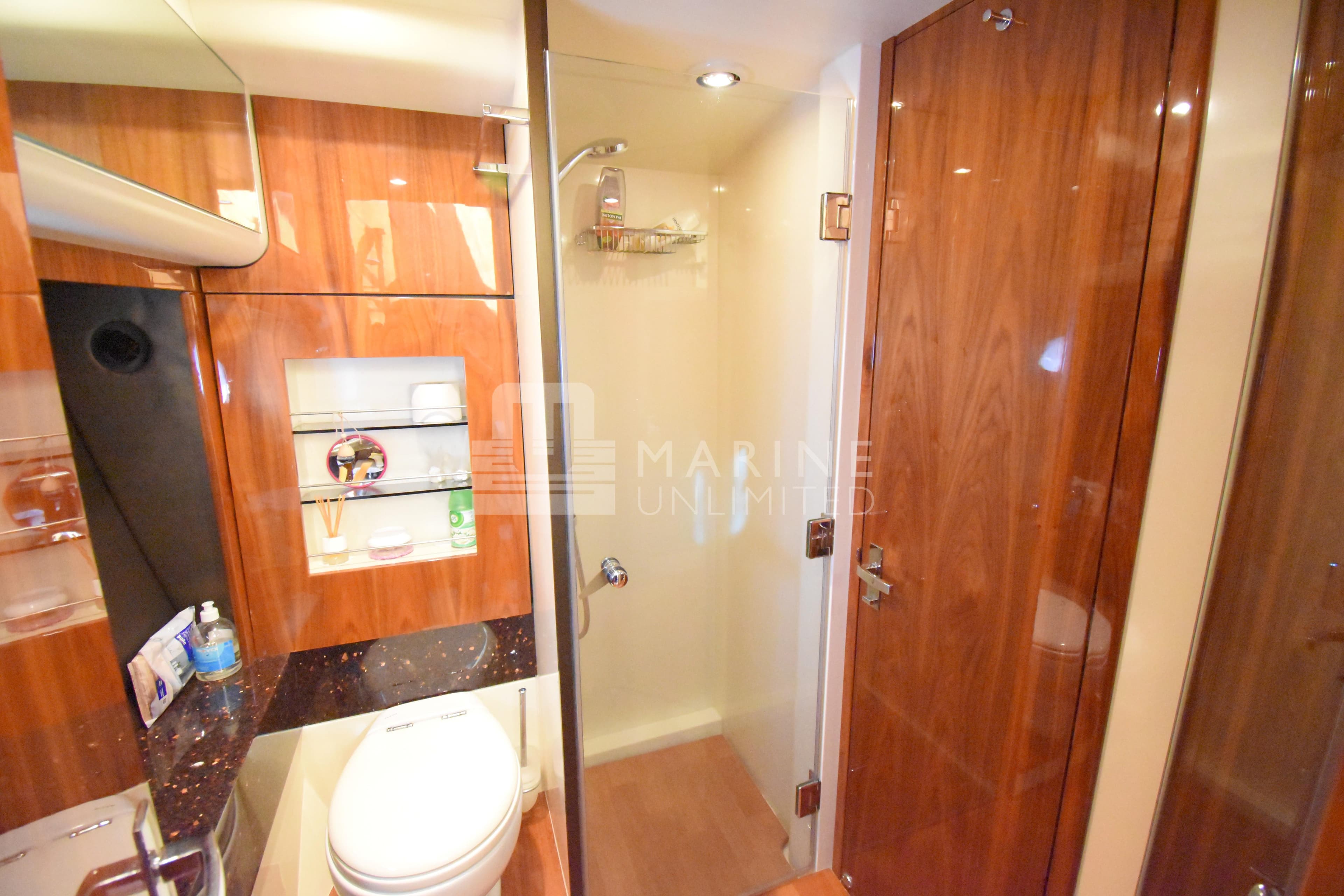 Luxurious bathroom in 2010 Fairline Squadron 55 yacht with wood accents and modern fixtures.