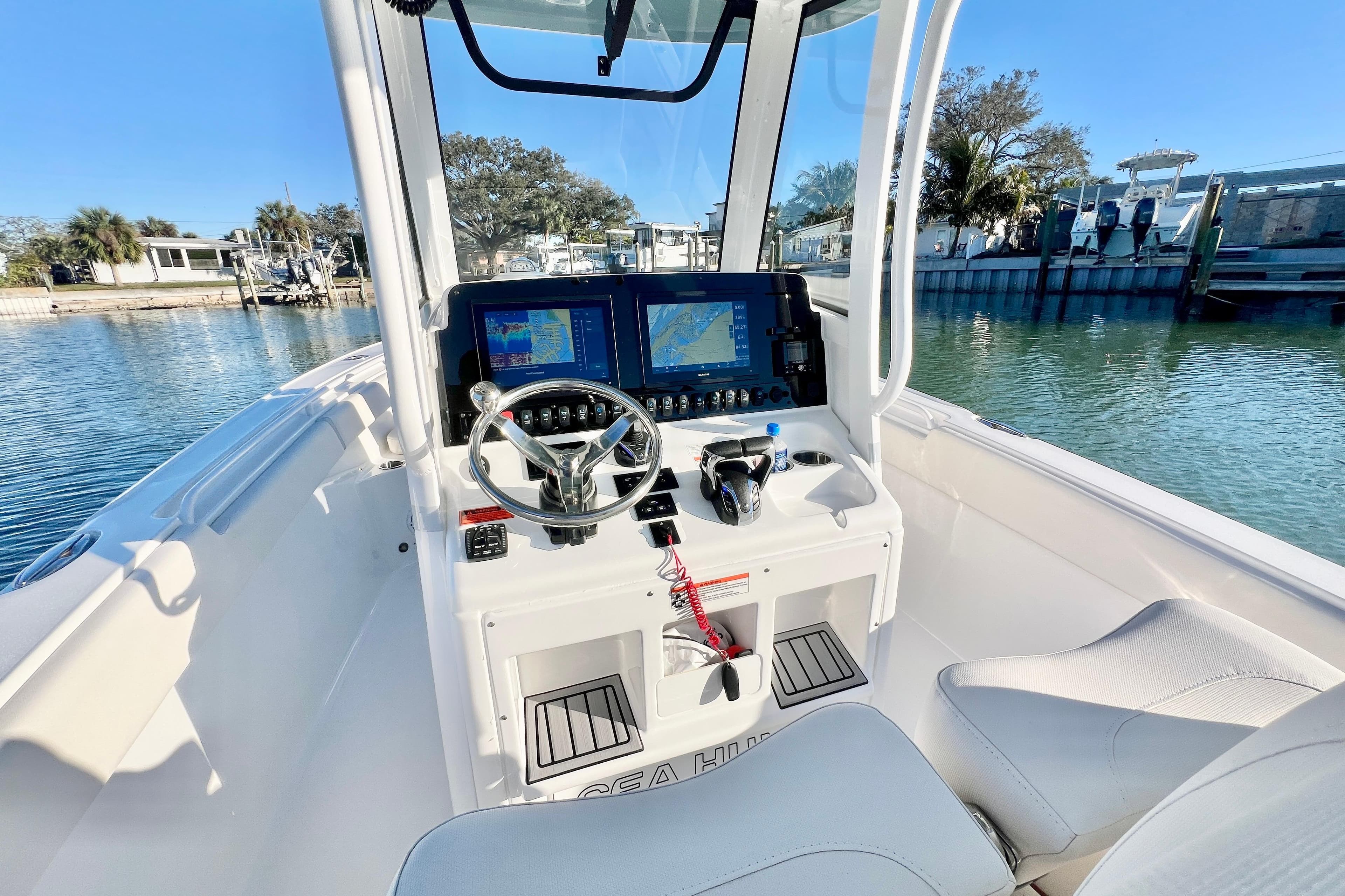 2022 Sea Hunt Ultra 265 SE boat cockpit with modern navigation system and steering wheel.