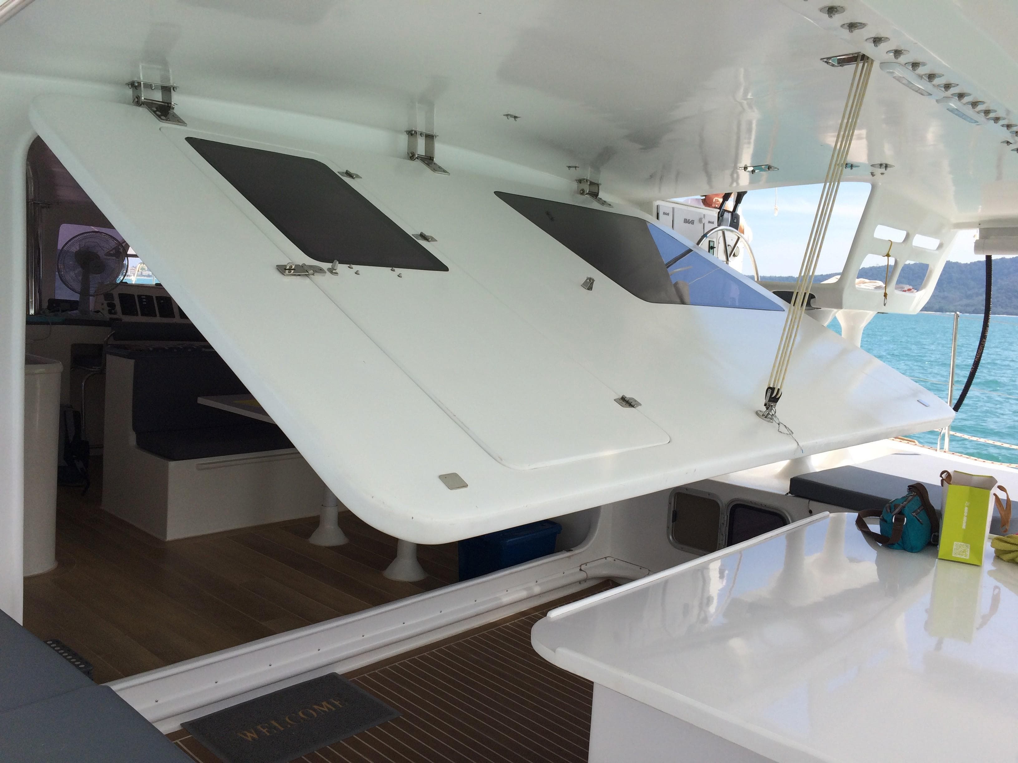 2022 Catathai 43 yacht interior with open deck hatch, showcasing modern design and ocean view.