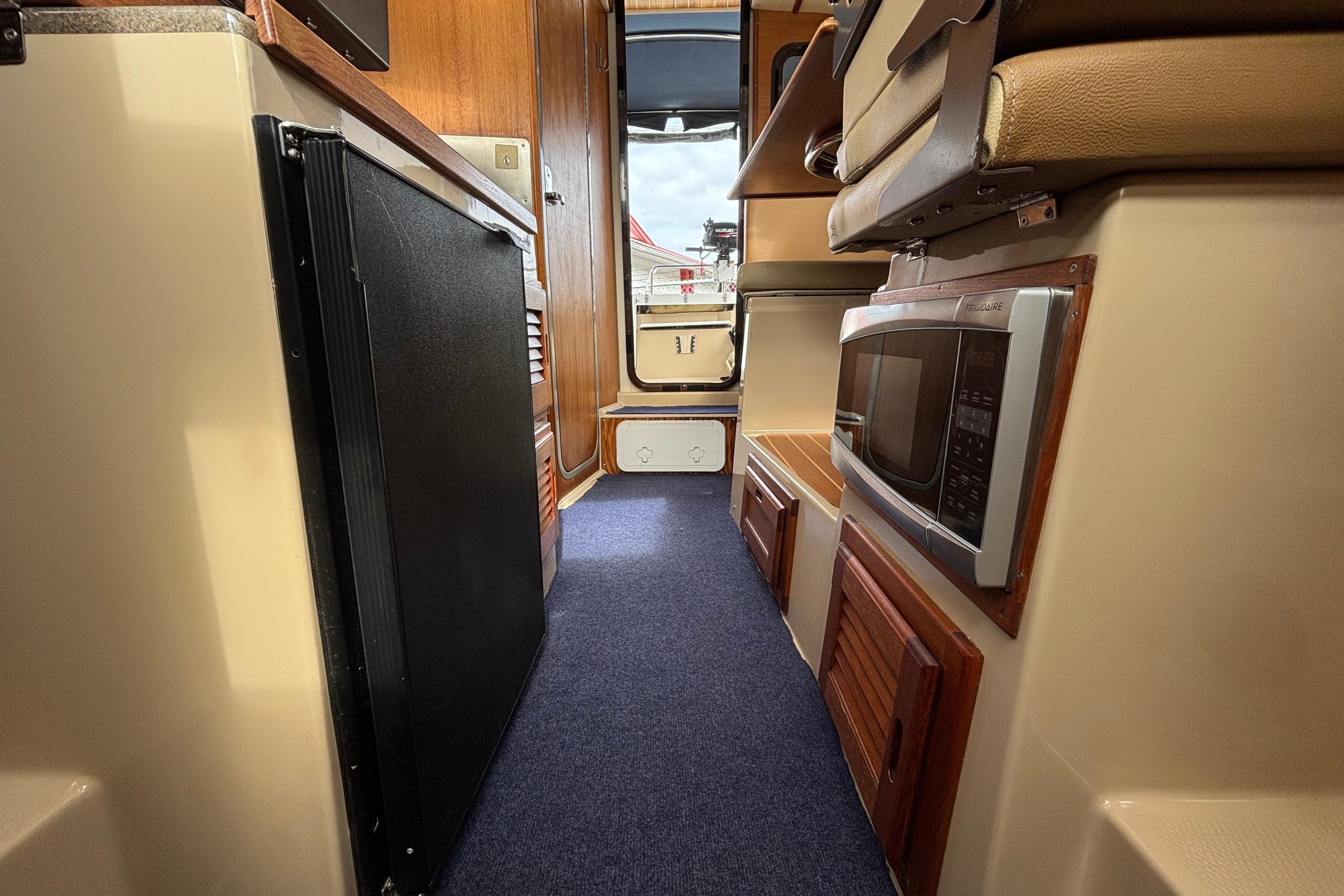 Interior of a 2013 Ranger Tugs R-25 SC boat, featuring a compact kitchen area.