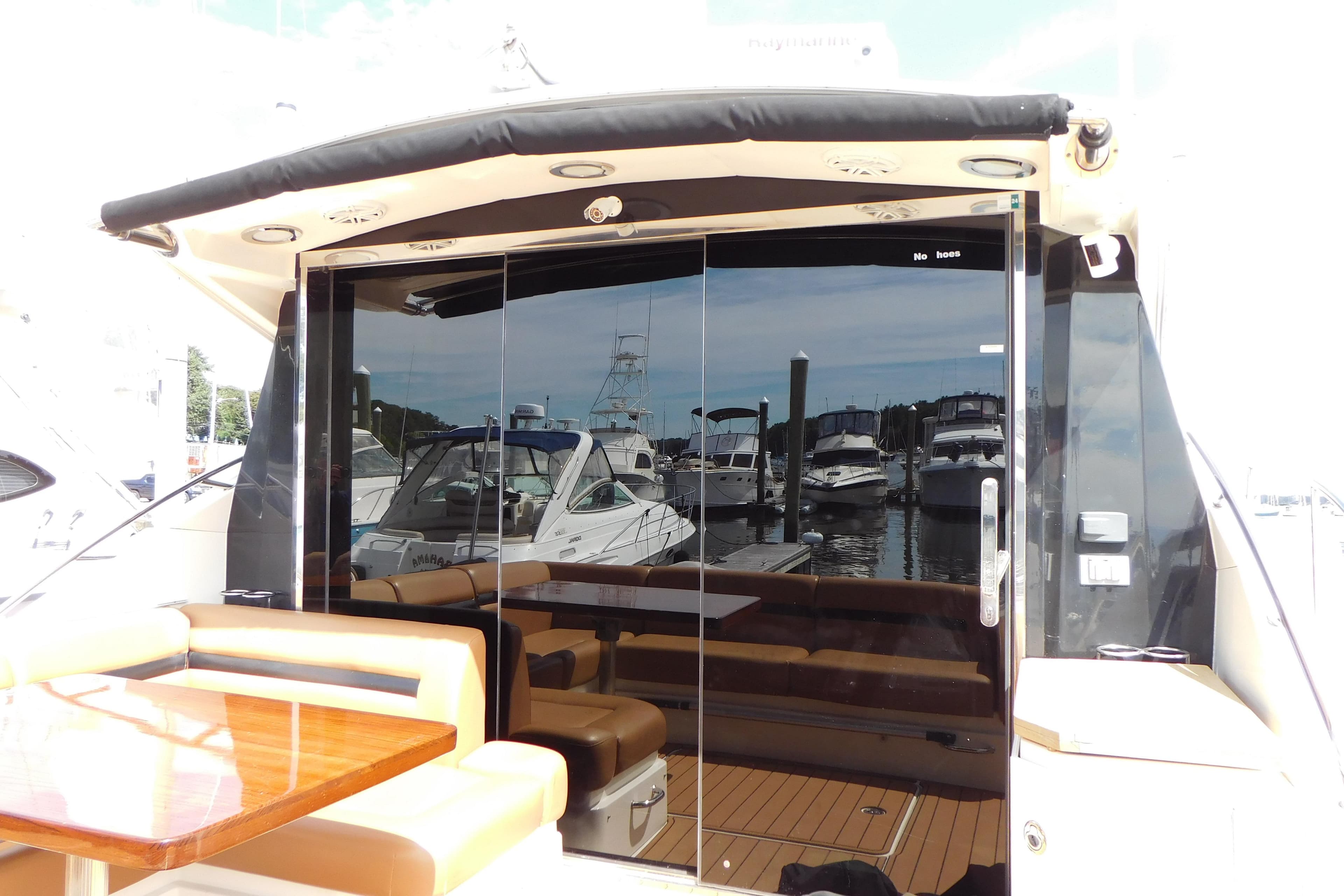 2013 Sea Ray 510 Sundancer yacht with sleek glass doors and luxurious seating area.