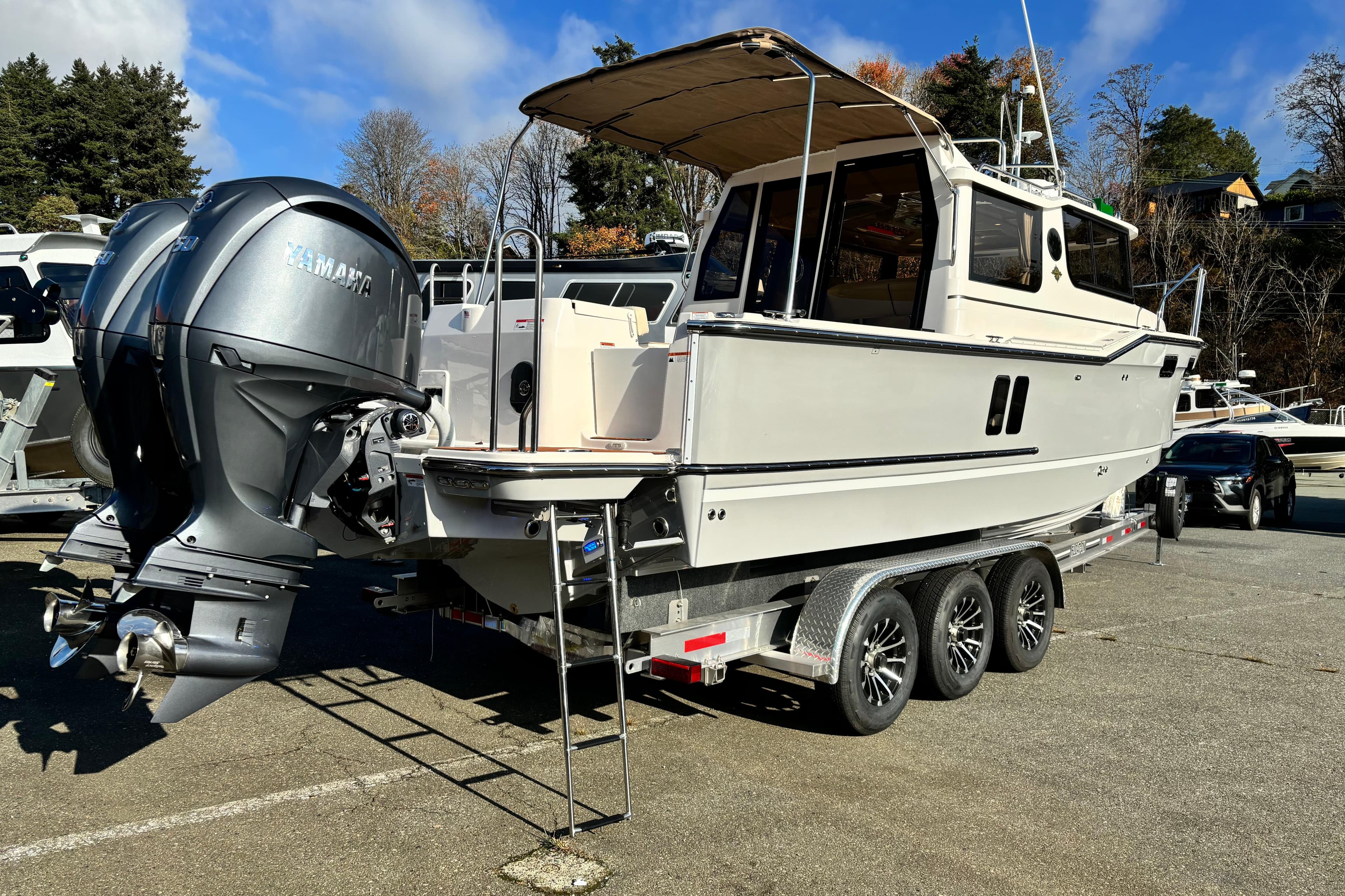 2026 Ranger Tugs R-27 boat on trailer with dual Yamaha outboard motors.