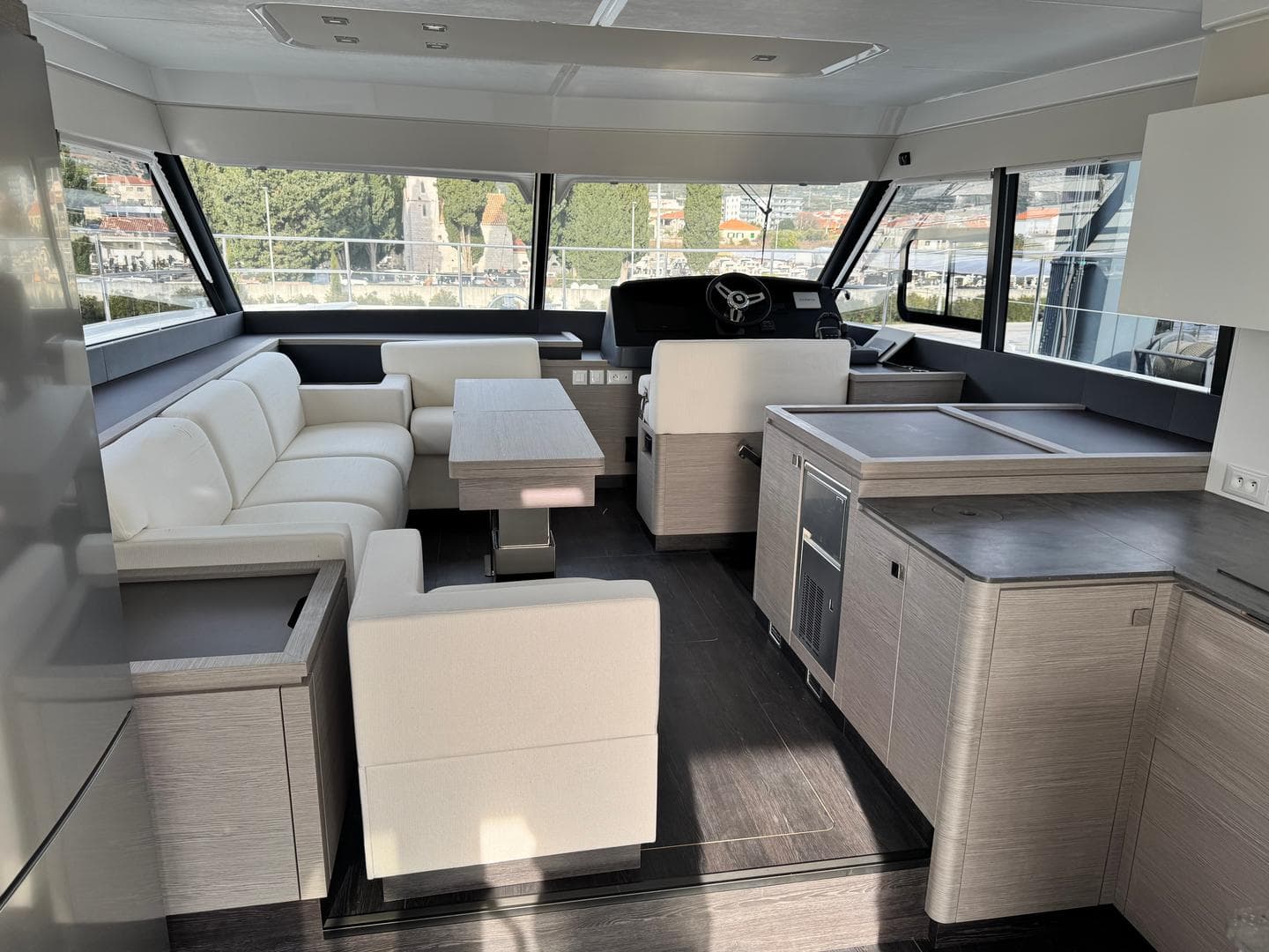 Luxurious interior of 2025 Fountaine Pajot MY5 yacht with modern furnishings and panoramic windows.