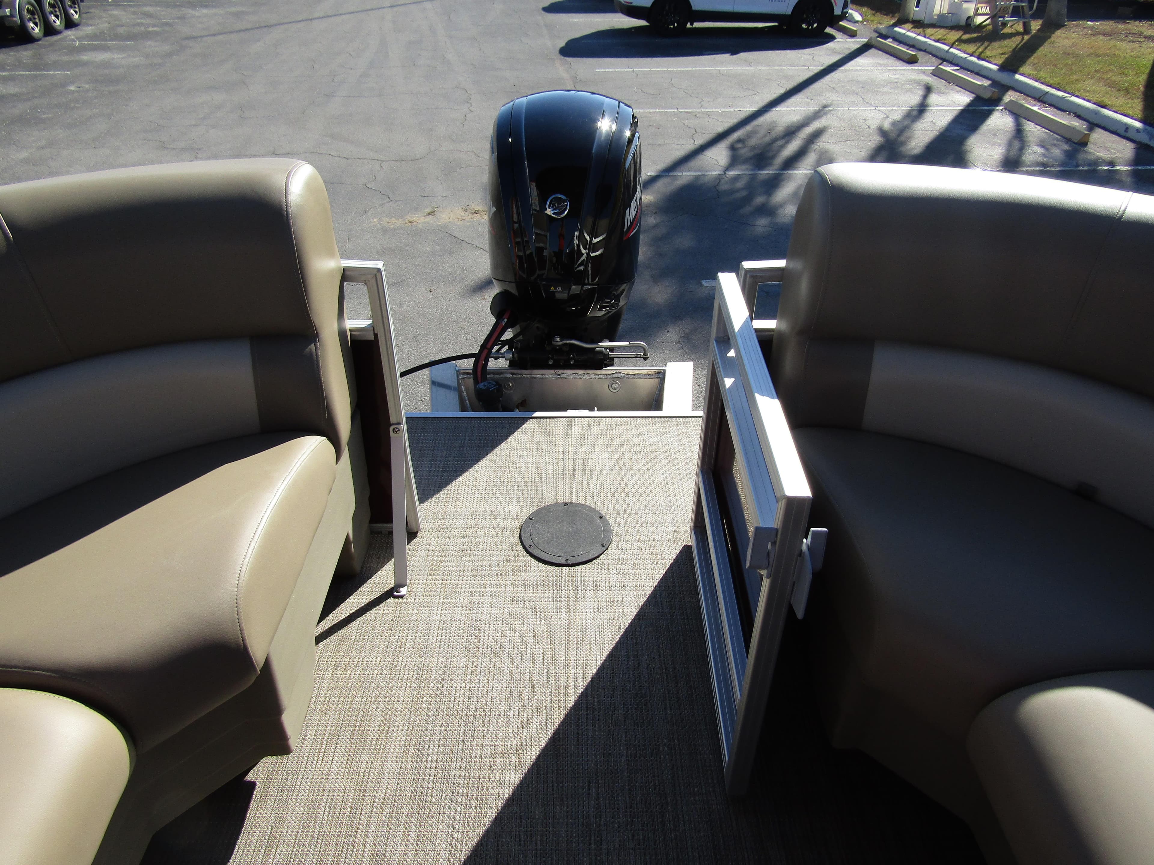2024 Starcraft LX 20 R pontoon boat interior with seating and outboard motor.