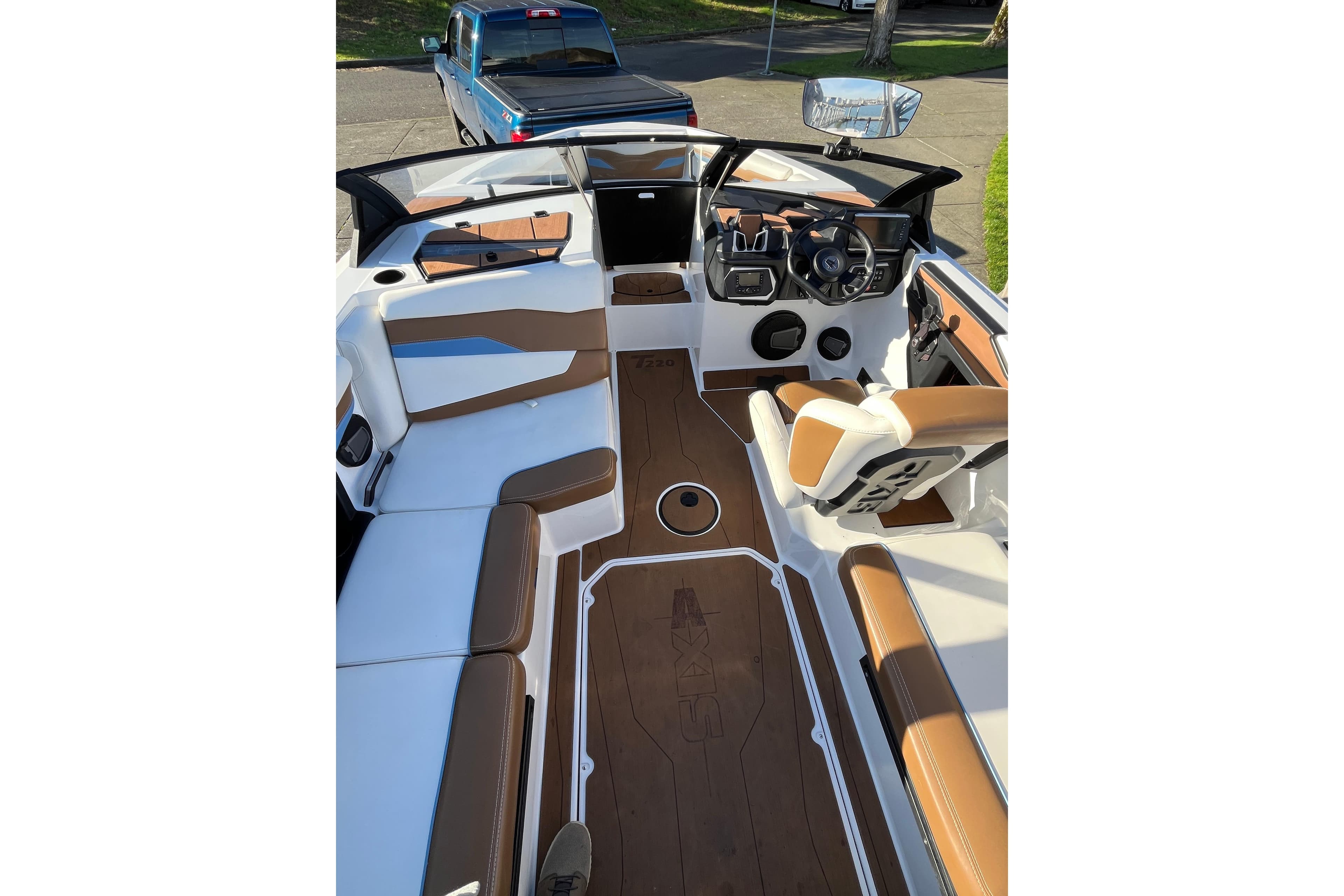 2024 Axis T220 boat interior with brown and white seating, modern dashboard, and spacious layout.