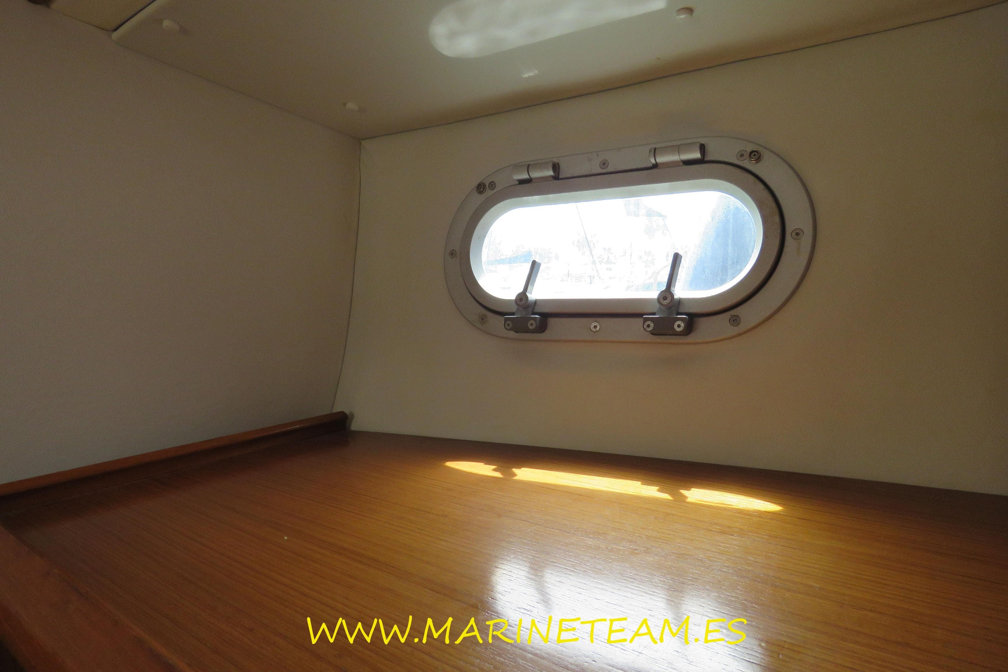 Interior cabin view of 1995 Jeanneau Sun Odyssey 45.1 with porthole window.