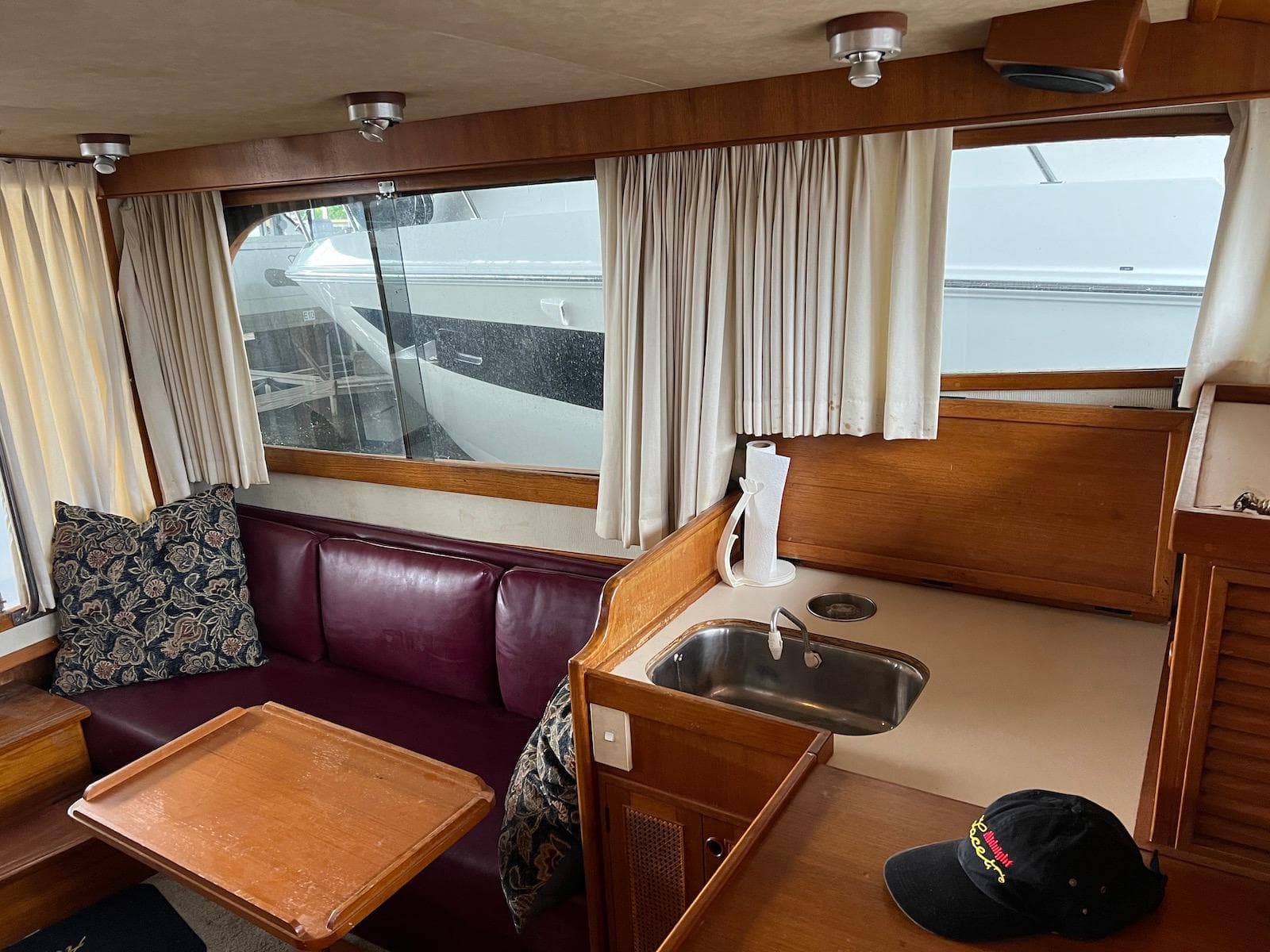 Interior of 1986 Midnight Lace 44 Flybridge Express Cruiser with seating and kitchenette.