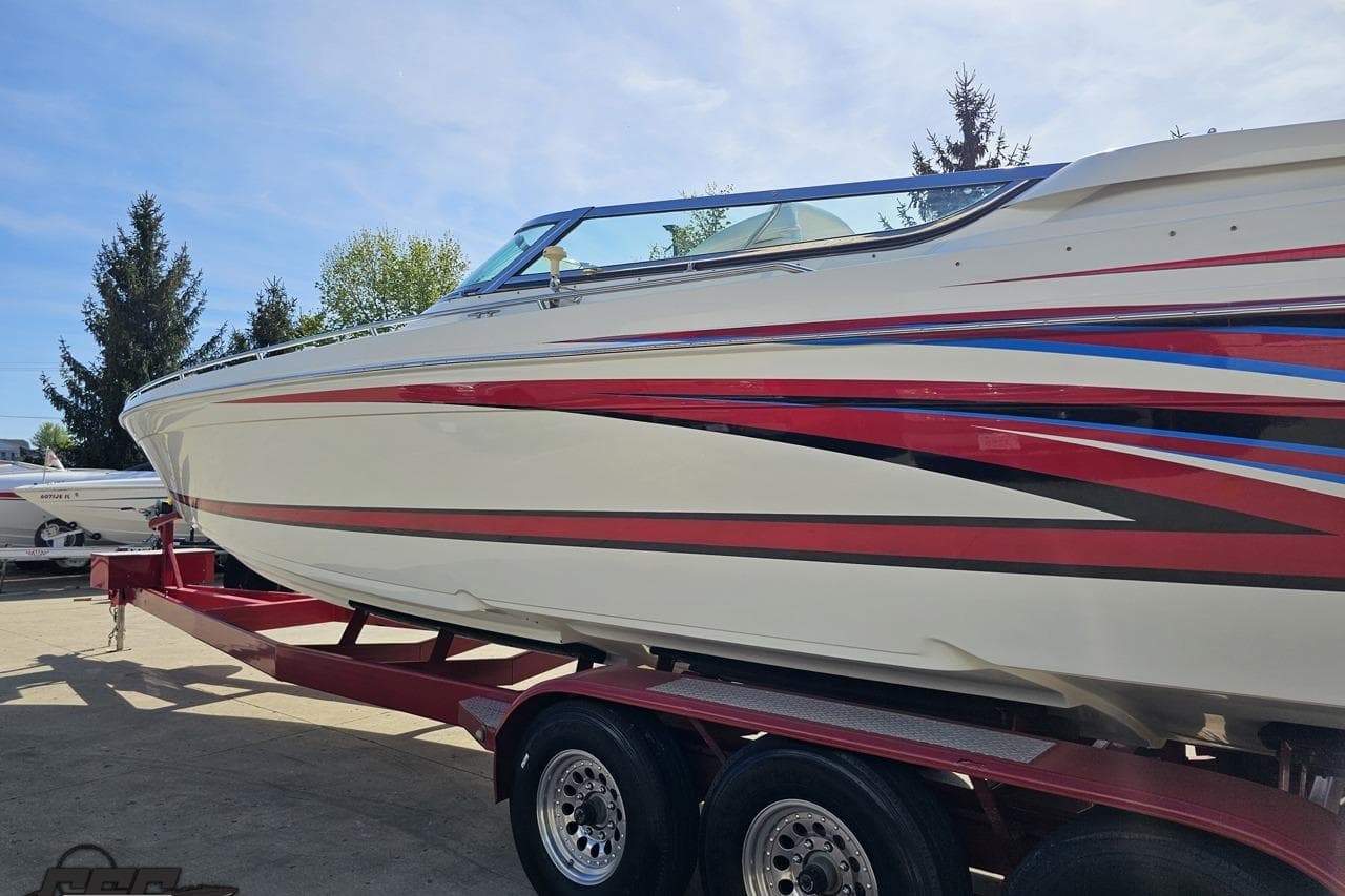 2001 Formula 382 FASTech boat on trailer, featuring sleek red and blue accents.