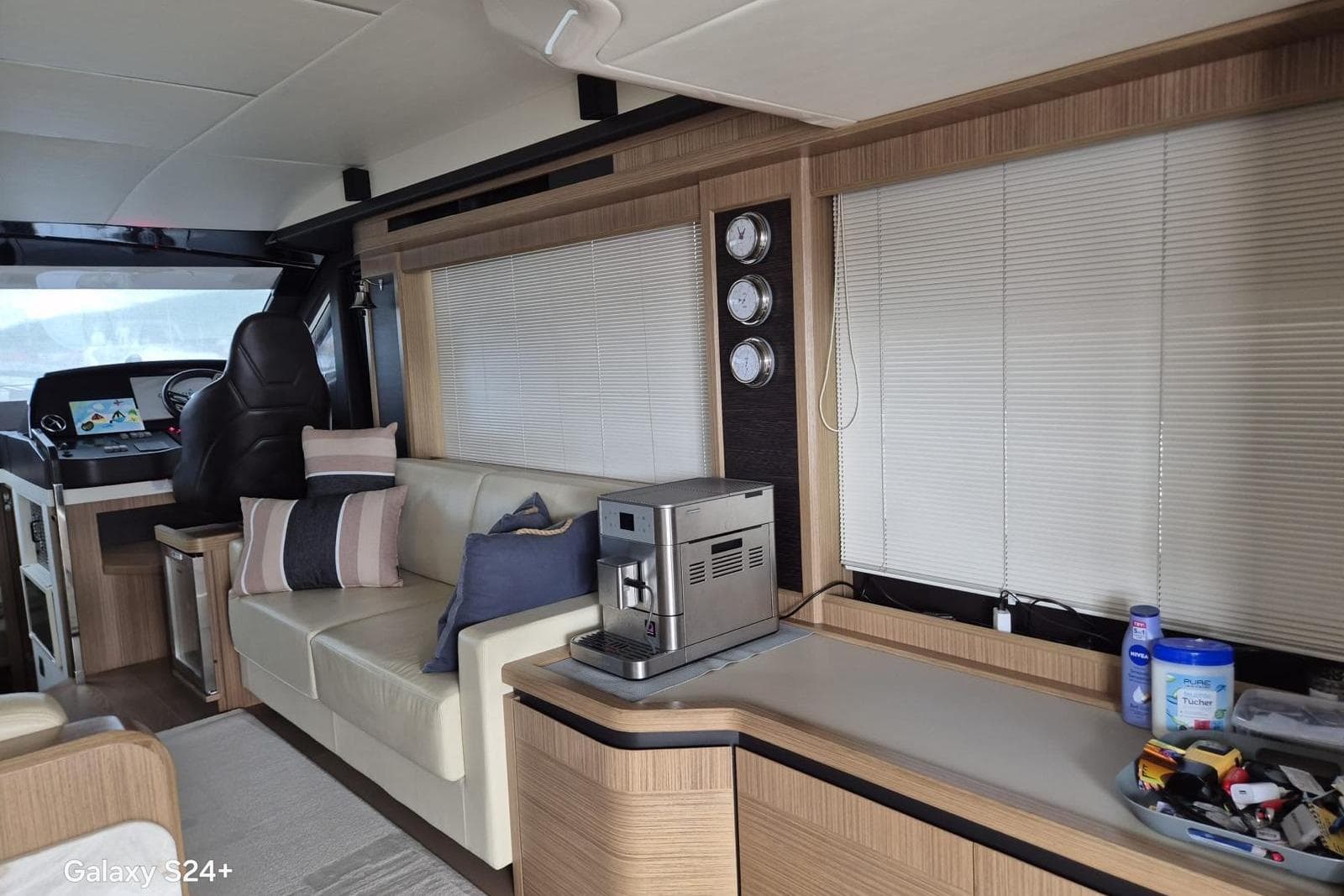 Luxurious interior of a 2018 Absolute 52 FLY yacht with modern furnishings and navigation area.