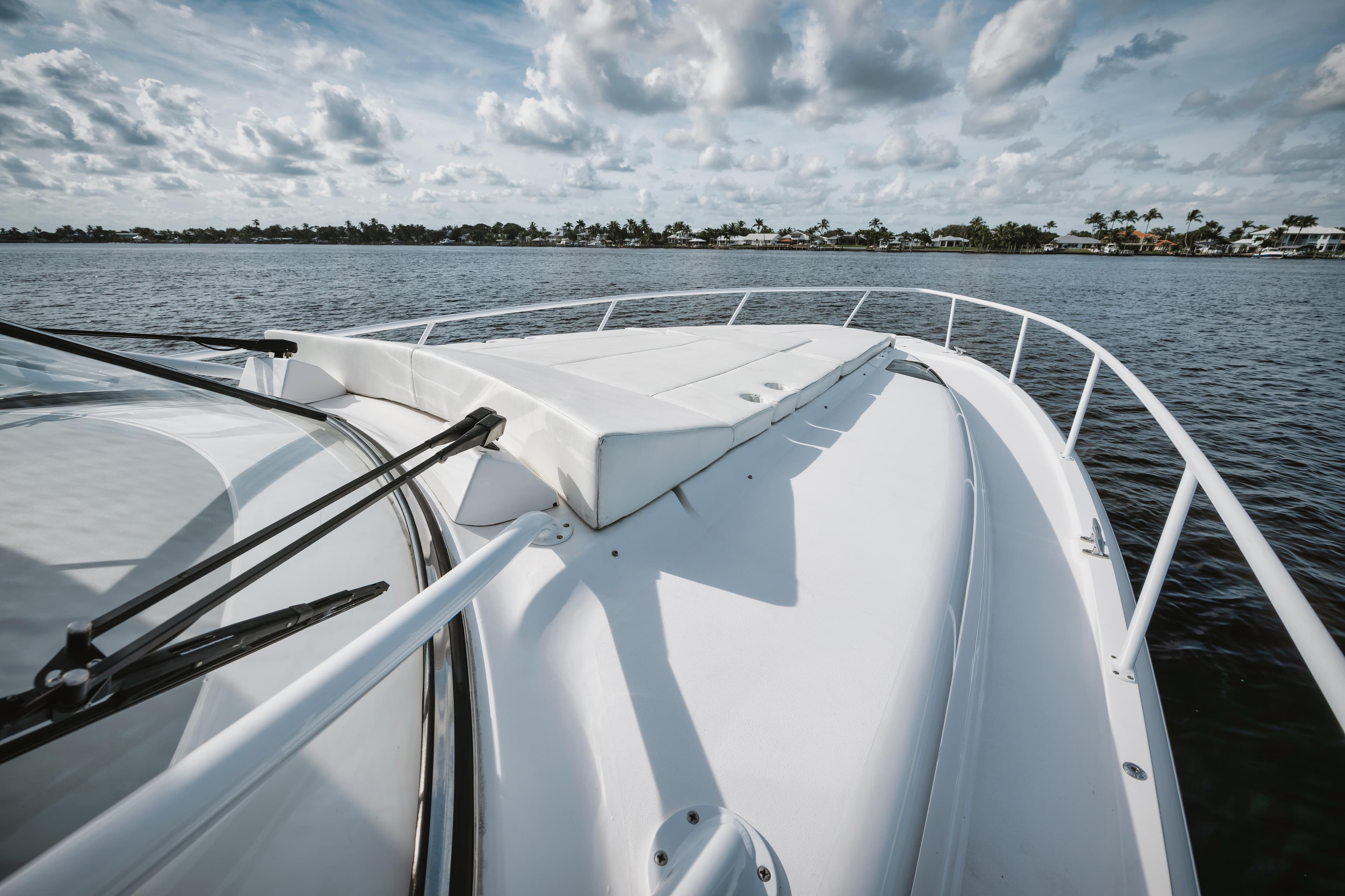 2018 Intrepid 475 Sport Yacht cruising on calm waters under a cloudy sky.