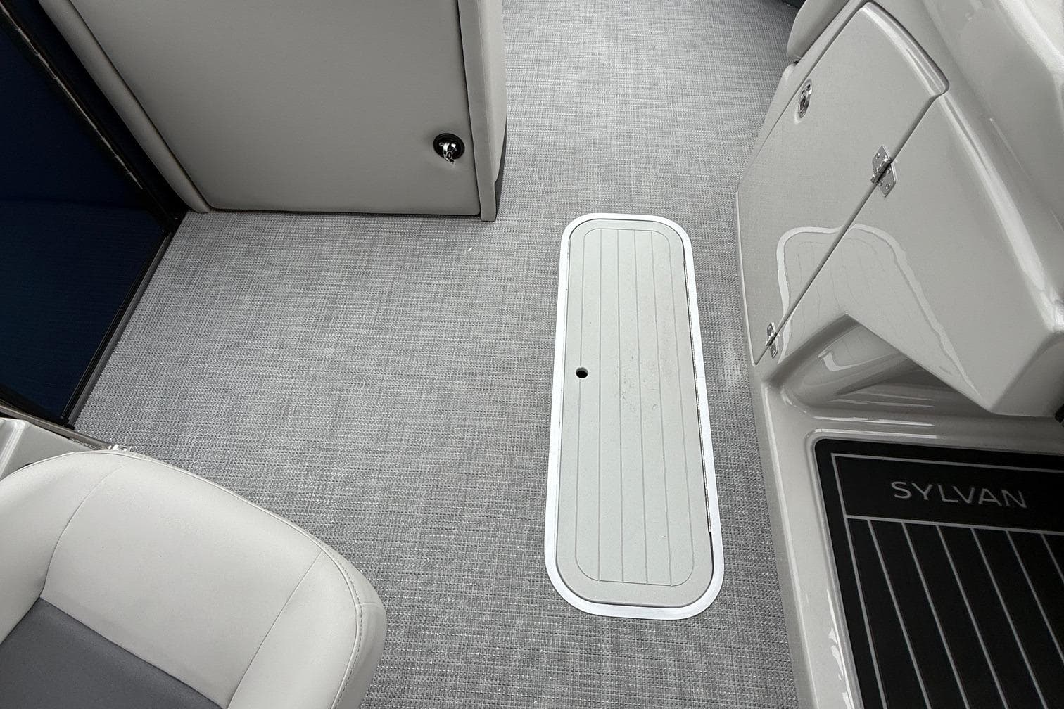 Interior of 2026 Sylvan L-3 RLZ DH boat with sleek flooring and seating.
