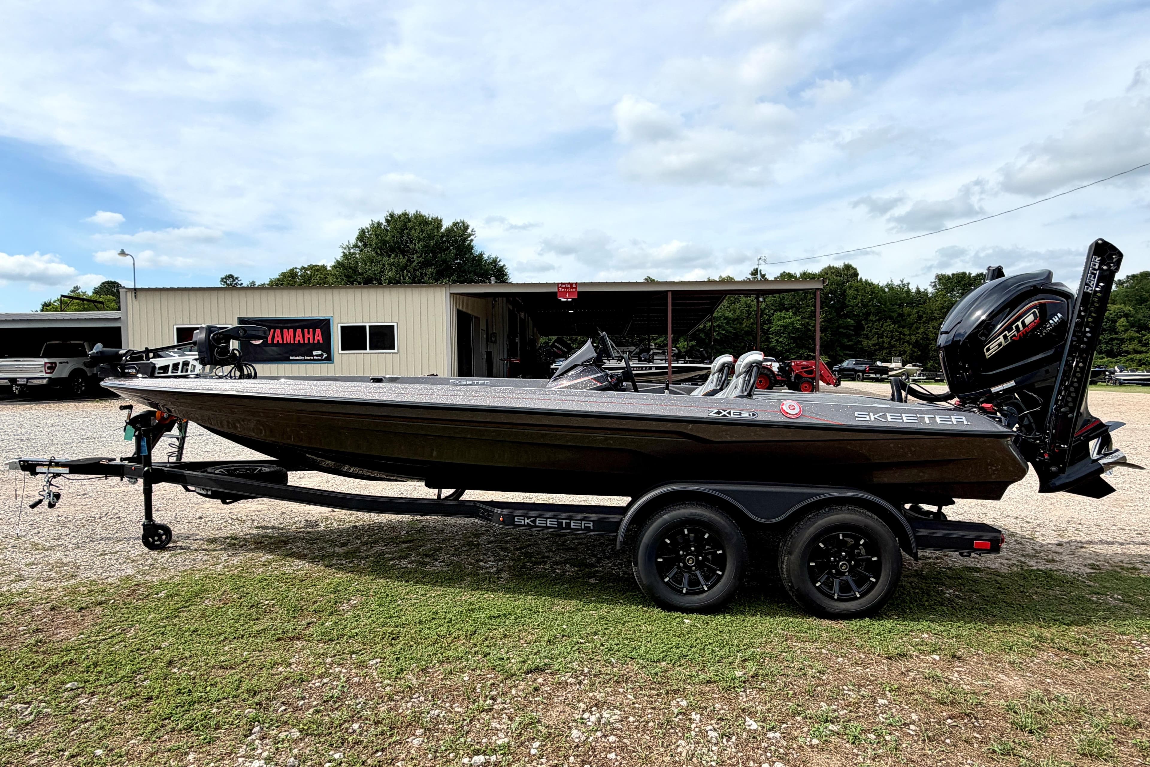 2026 Skeeter ZXE21 boat on trailer, parked outside a Yamaha dealership.