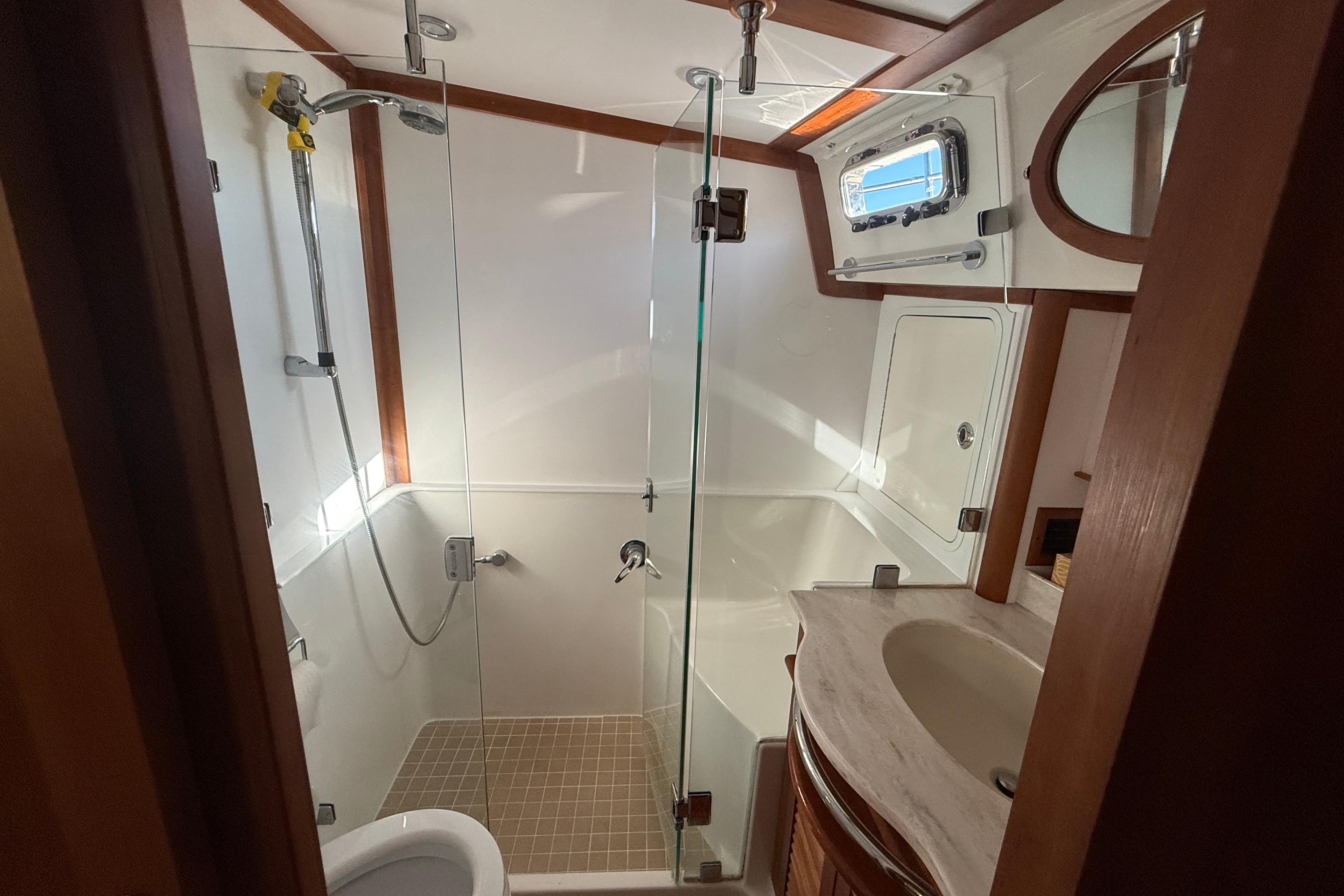 Luxurious bathroom in 2017 Sabre 48 Salon Express yacht with glass shower and modern fixtures.