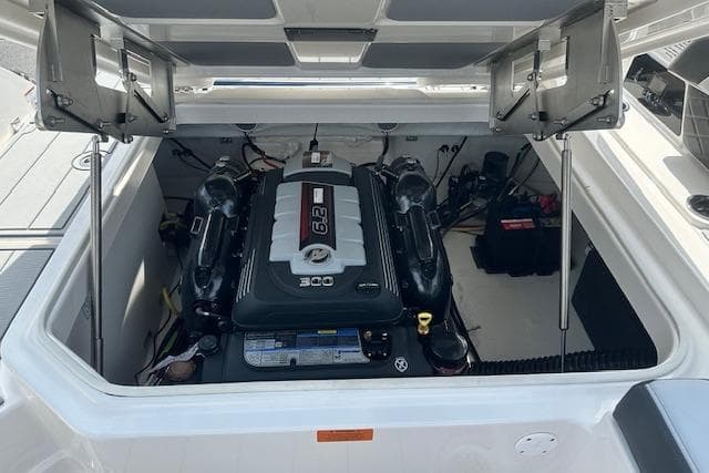 2026 Chaparral 6 SSX boat engine compartment with 6.2L engine, open hatch view.
