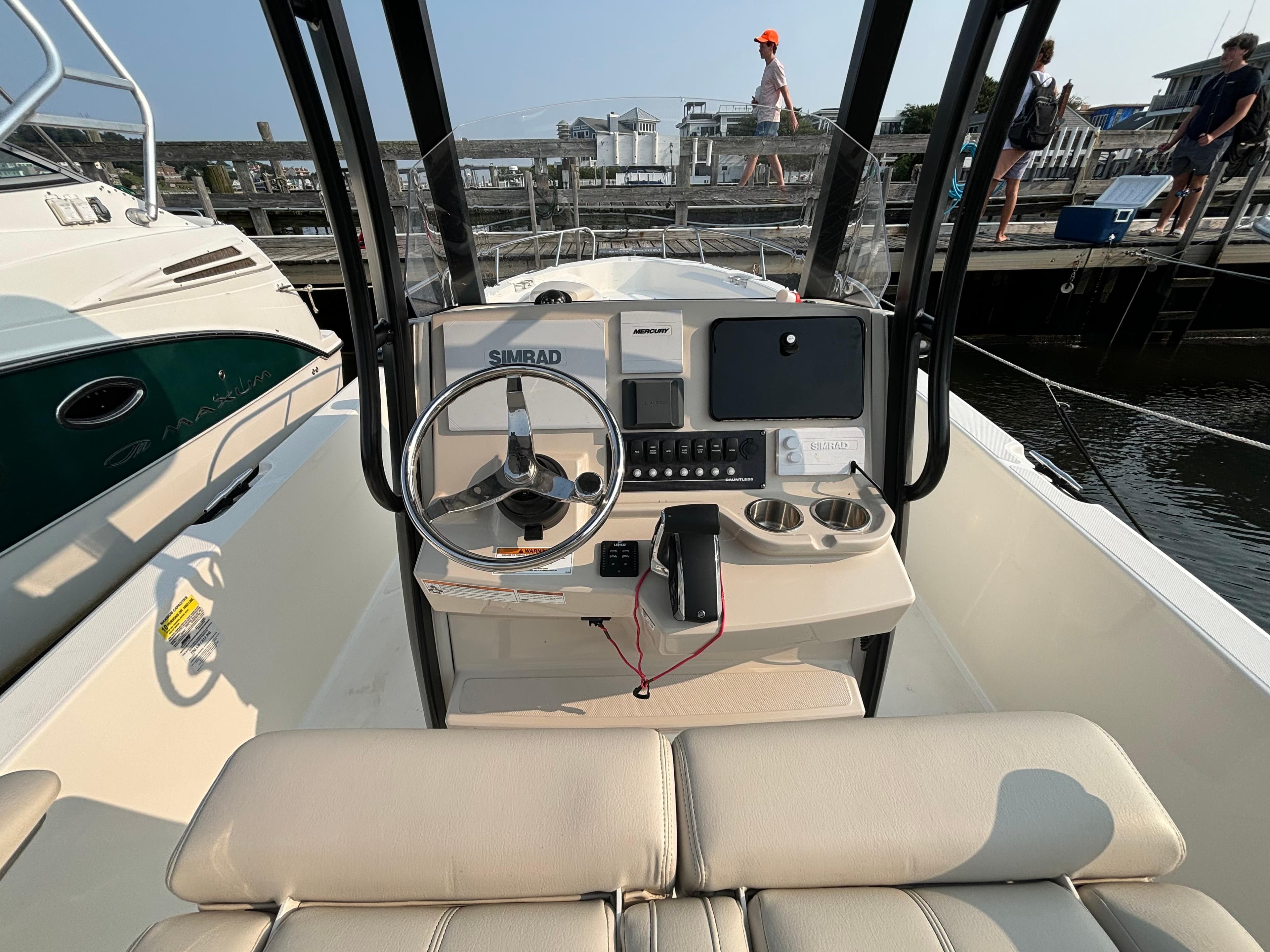 2023 Boston Whaler 250 Dauntless boat cockpit with steering wheel and navigation equipment.