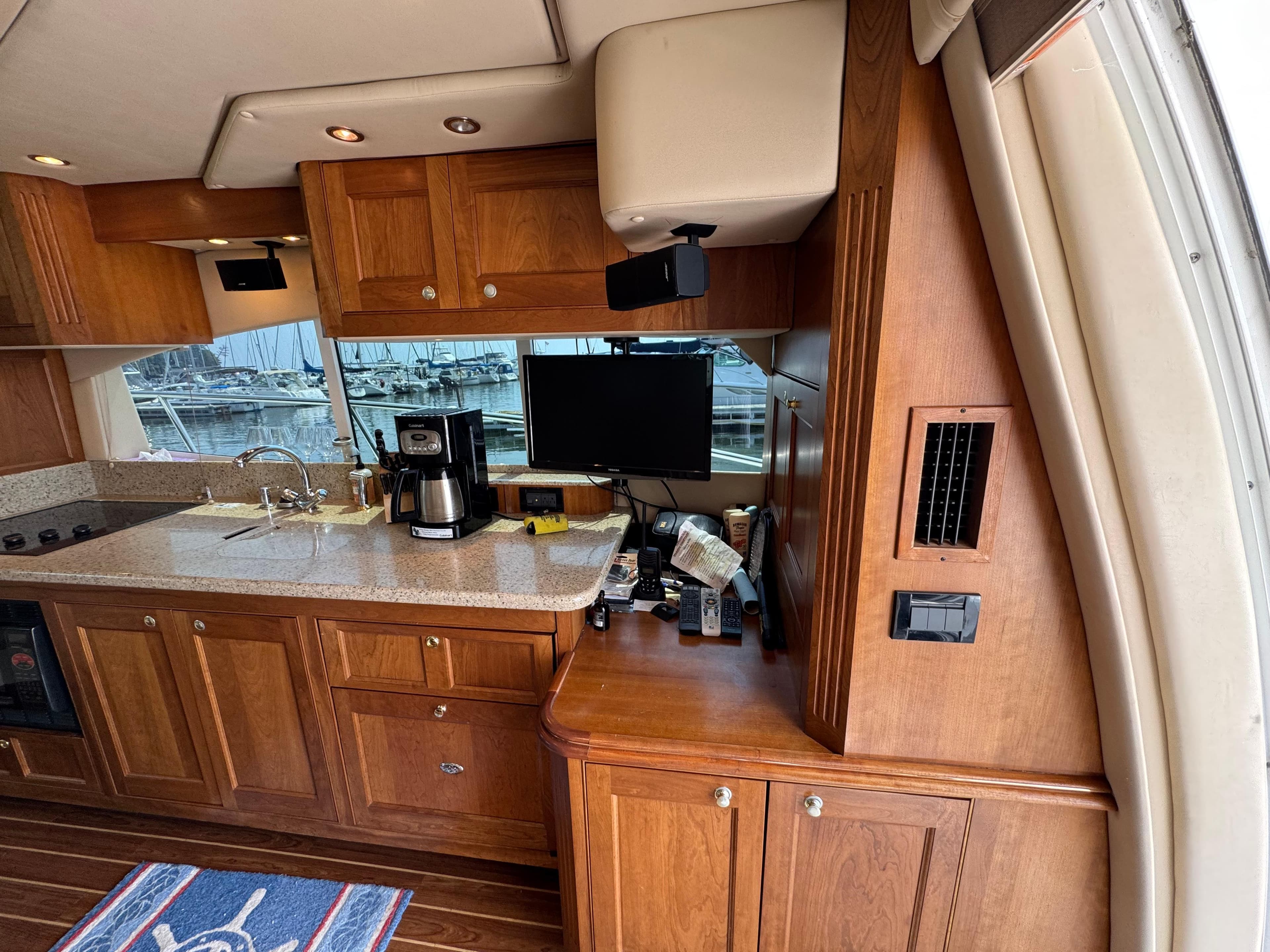 Luxurious 2003 Cruisers Yachts 5000 Sedan Sport interior with wooden cabinetry and modern amenities.