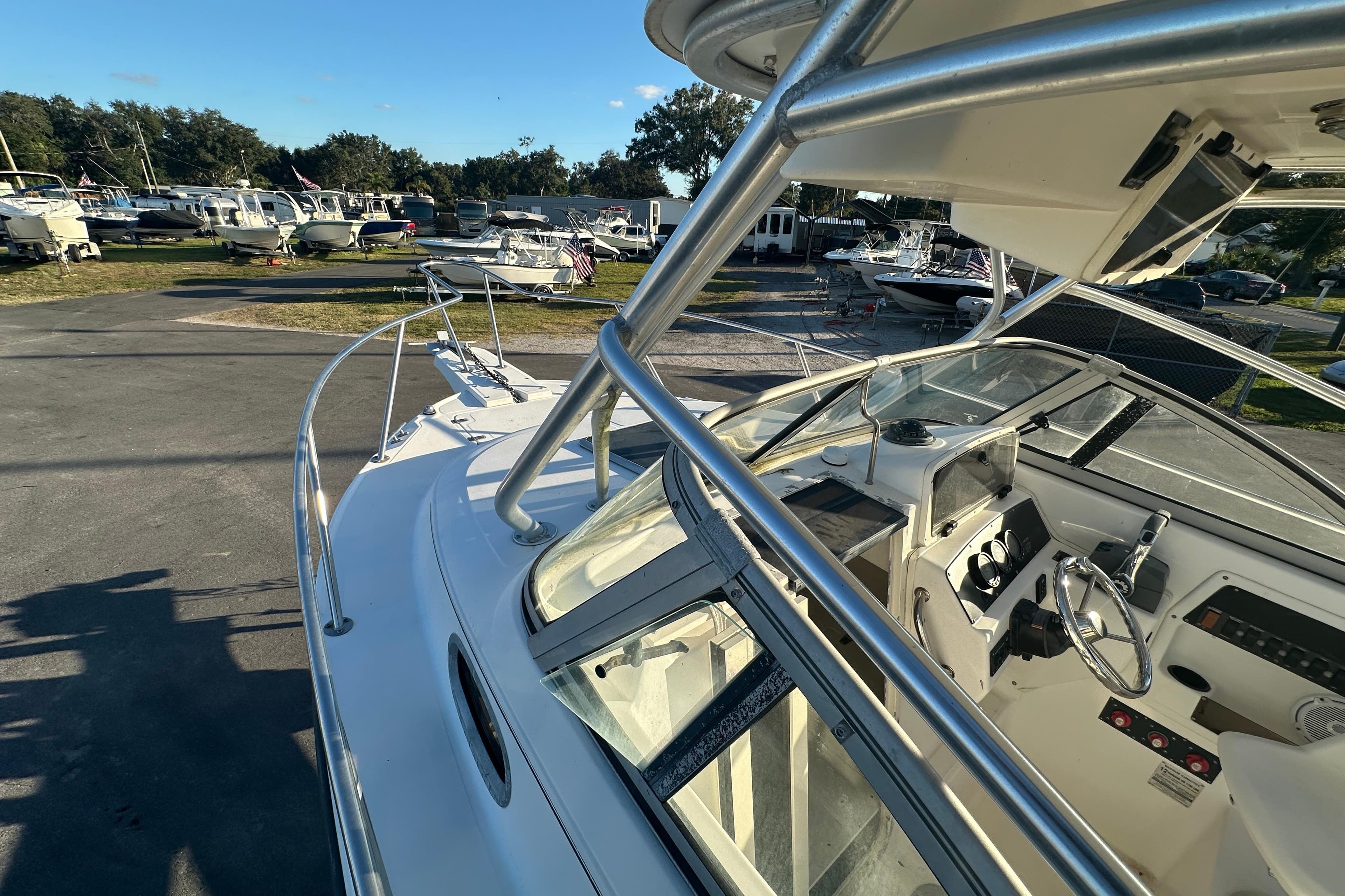 2001 Boston Whaler 23 Conquest boat interior with steering wheel and controls.