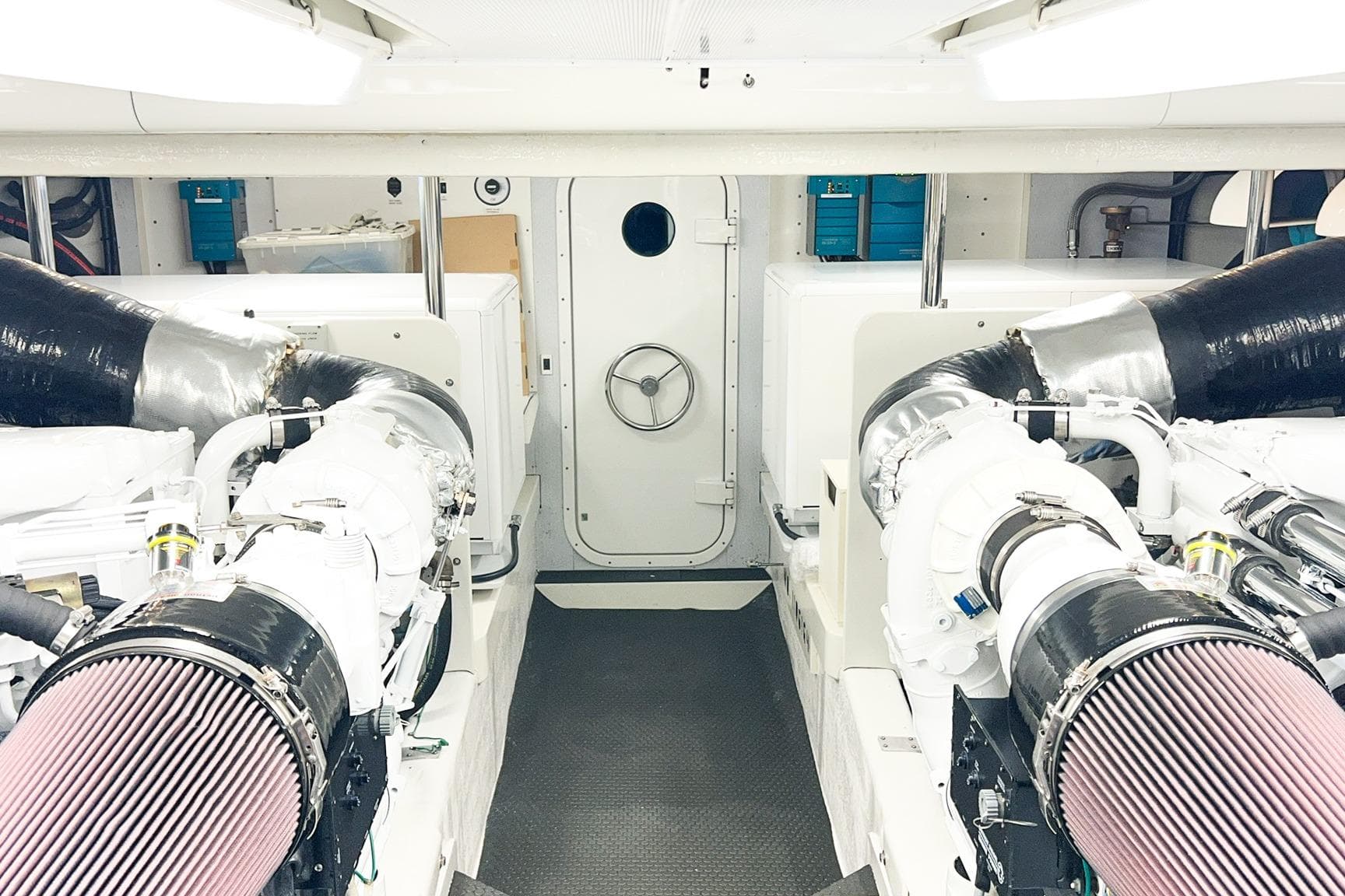 Engine room of 2001 Nordlund Enclosed Command Bridge yacht, featuring dual engines and modern equipment.