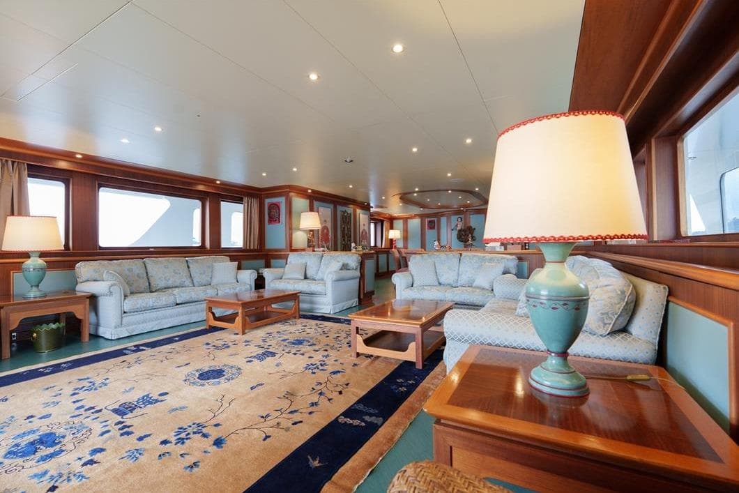 Luxurious interior of 2001 Baglietto New Master yacht with elegant sofas and decorative lamps.
