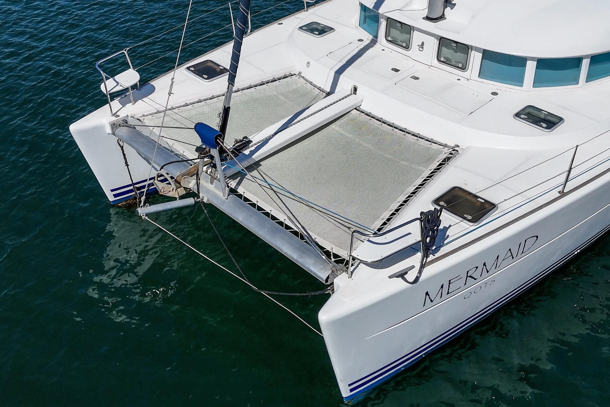 Lagoon 380 catamaran, 2004 model, named "Mermaid," on calm blue water.