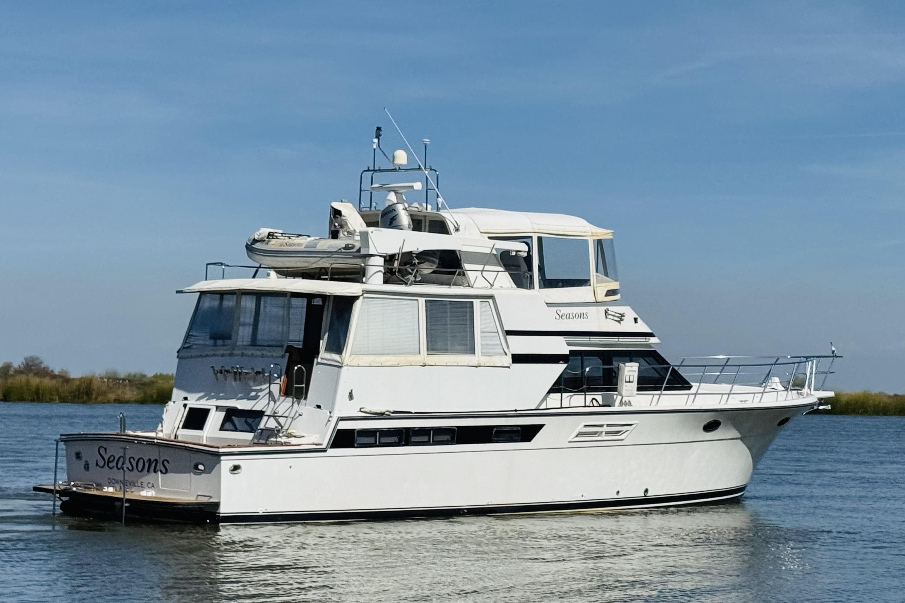 1991 Californian 55 Cockpit Motor Yacht on calm water under clear sky.
