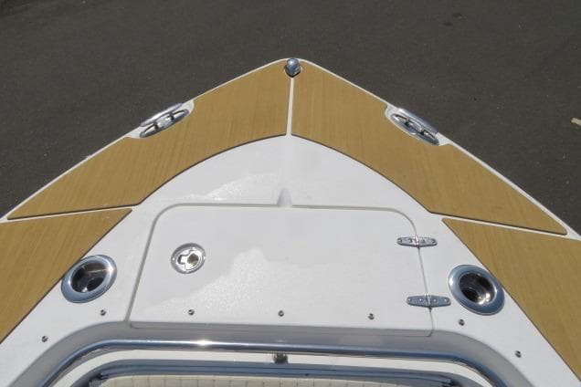 Bow of 2006 Sea Hunt Triton 260 boat with tan and white deck.