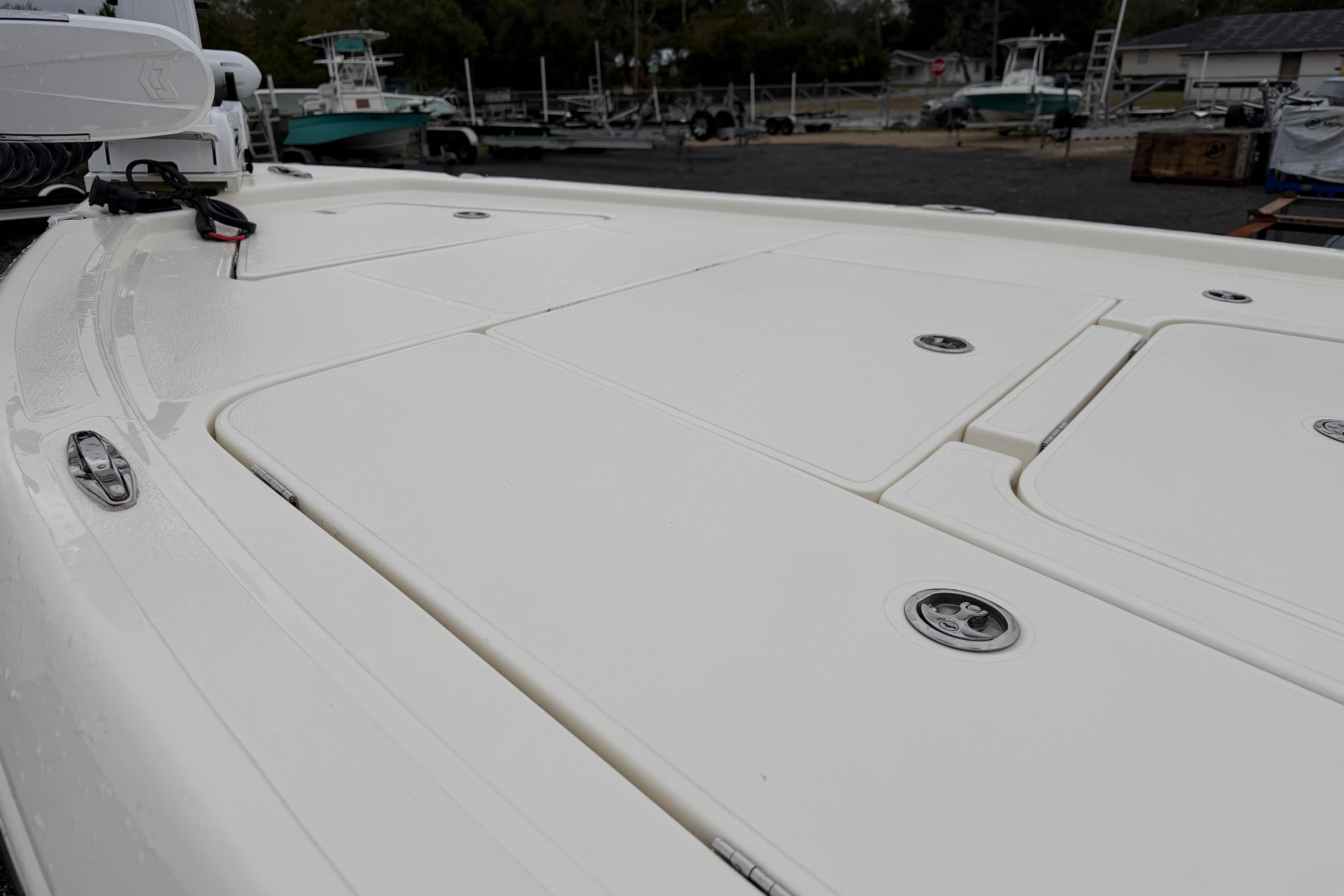 2025 Skeeter SX241 boat deck with storage compartments, in a marina setting.