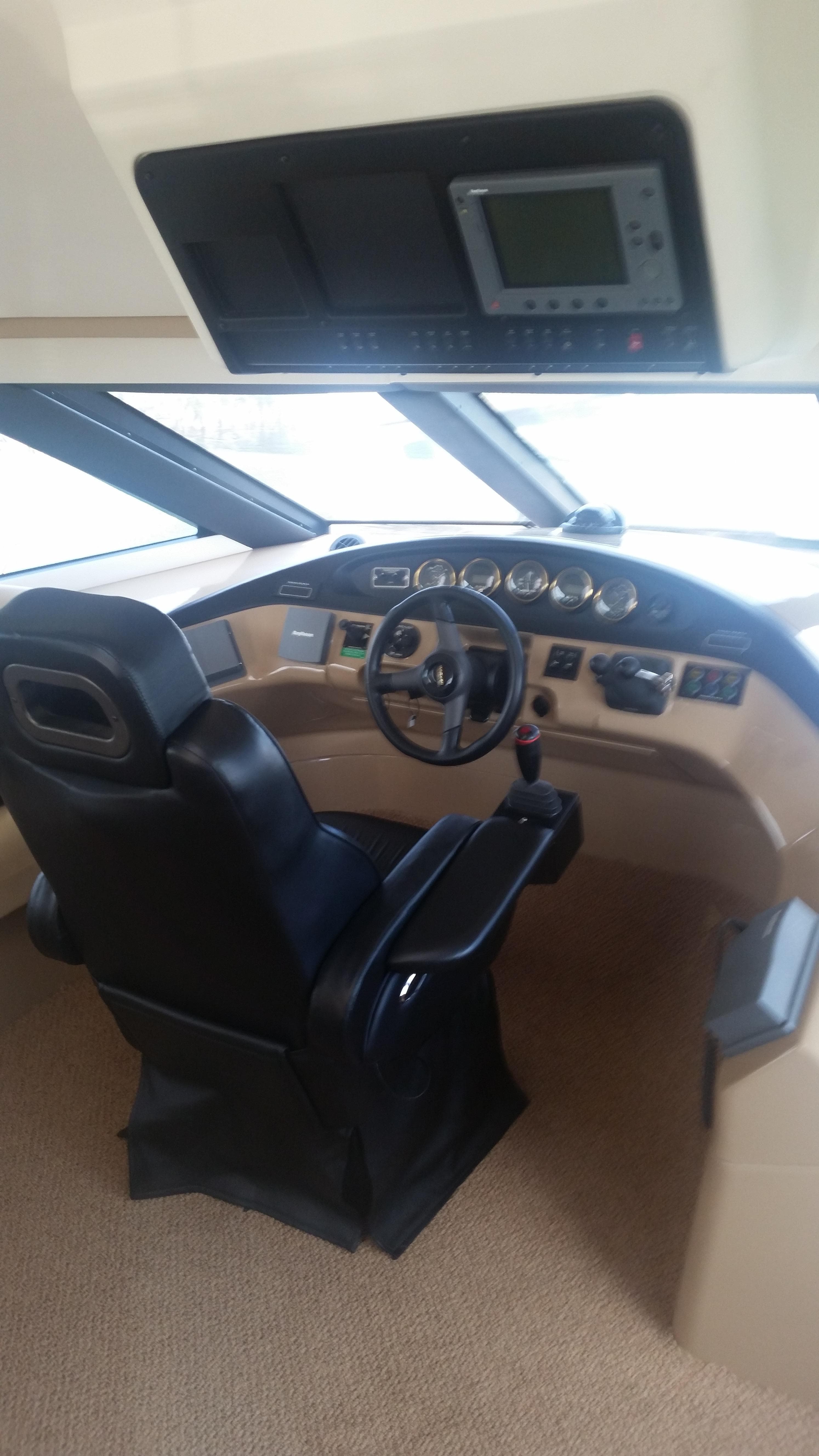 1999 Carver 530 Voyager Pilothouse helm with modern navigation equipment.