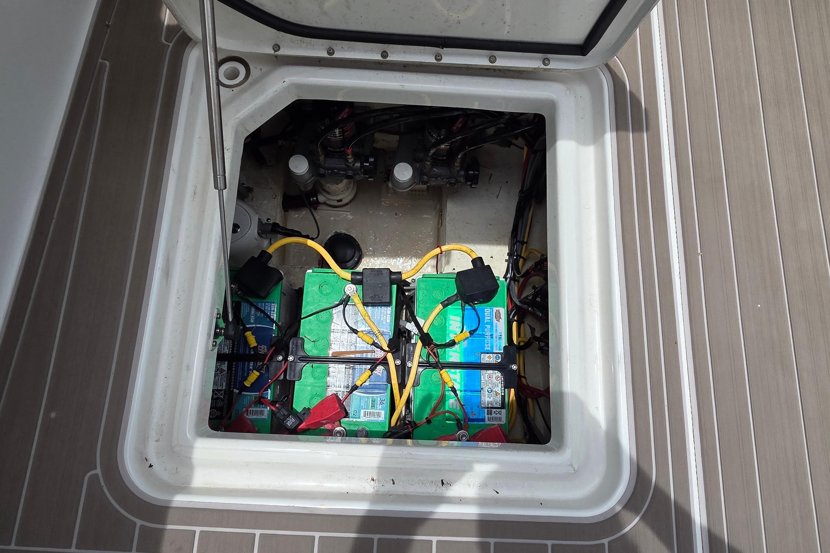 Battery compartment of 2023 World Cat 280 DC-X boat, showing wiring and connections.