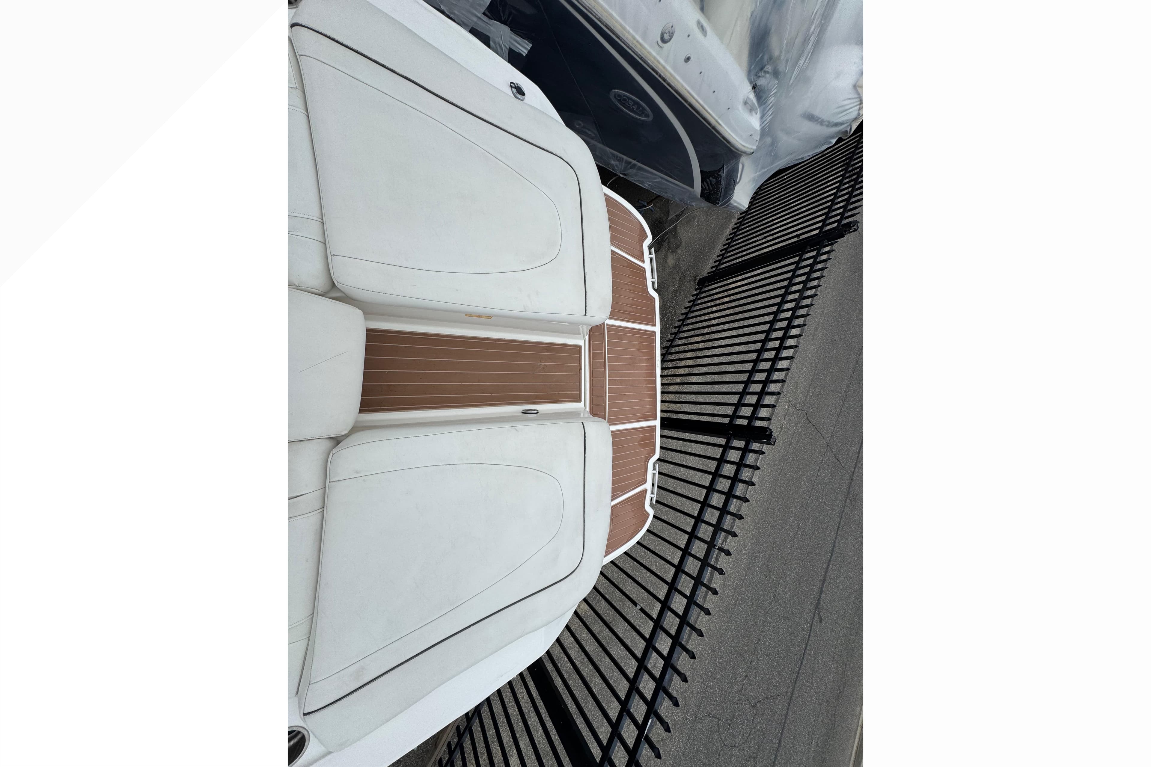 2007 Sea Ray 270 SLX boat with white seating and wooden deck, viewed from above.