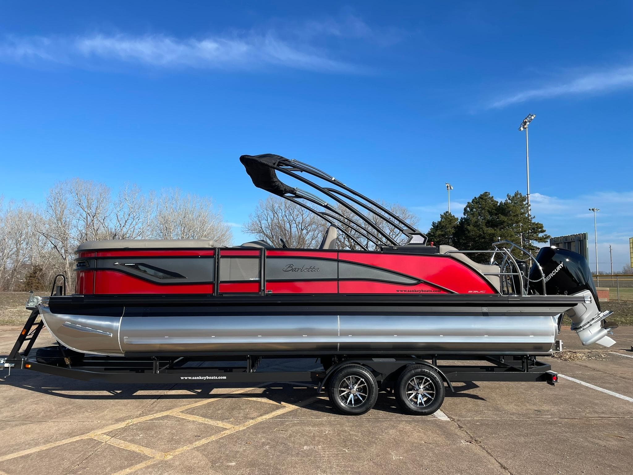 2024 Barletta CORSA 23UCA pontoon boat in red and black on a trailer.
