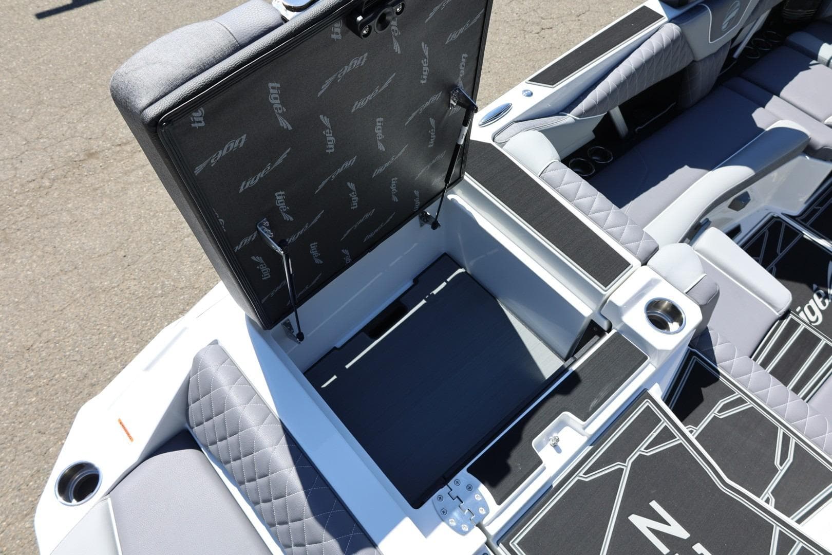 2026 Tigé Z3 boat interior with open storage compartment and quilted seating.