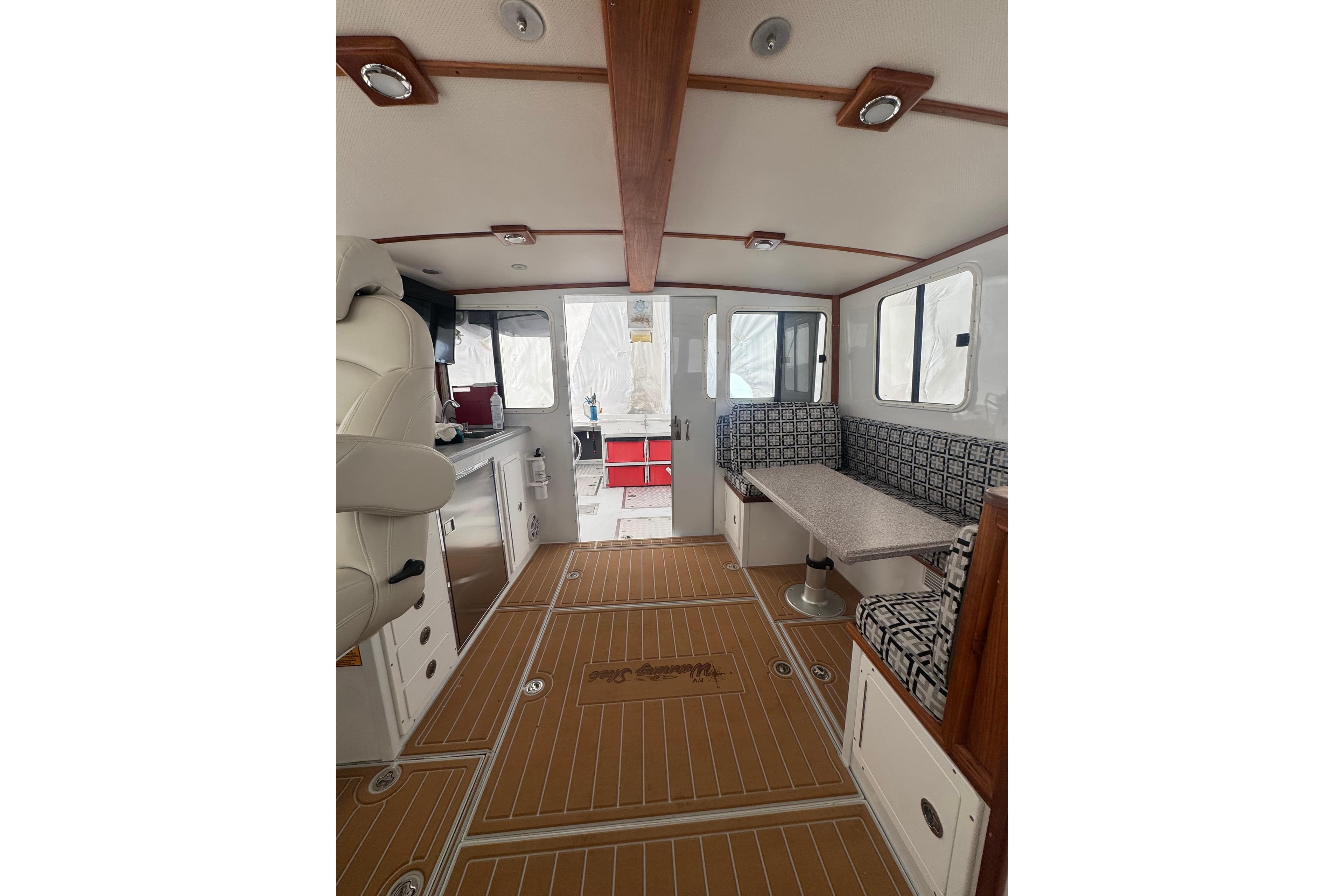 Interior of 2000 Northern Bay 38 boat with seating and kitchenette.