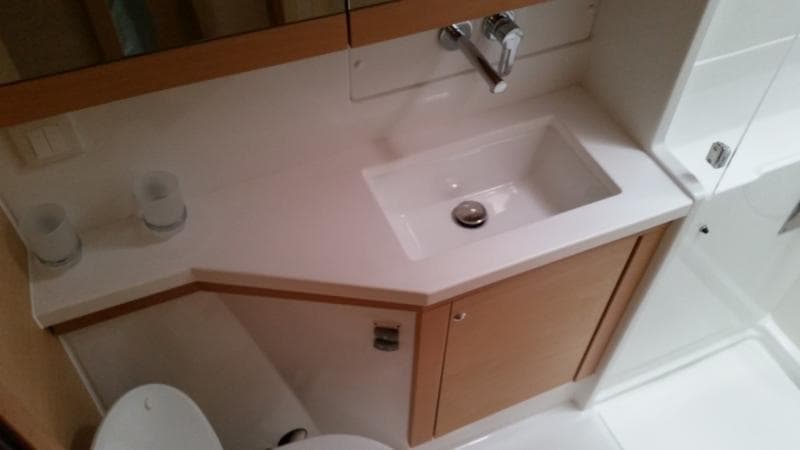 Modern bathroom interior of 2017 Lagoon 450S yacht, featuring sleek sink and cabinetry.