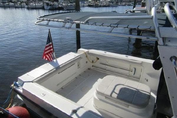 2000 Albin 28 Tournament Express boat docked, featuring spacious deck and American flag.