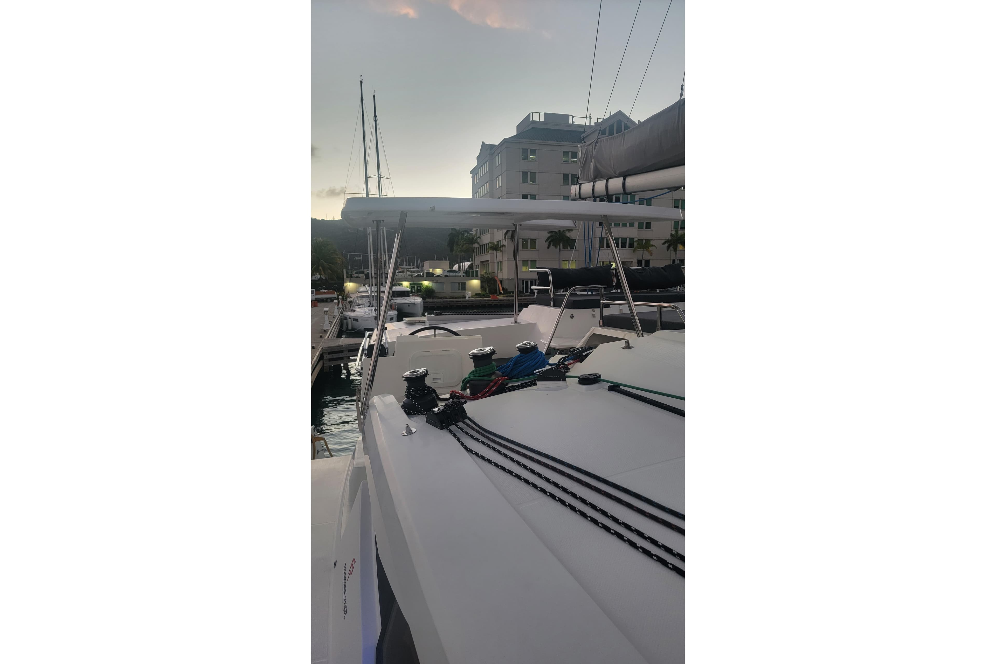 2019 Fountaine Pajot Saona 47 catamaran docked at marina during sunset.