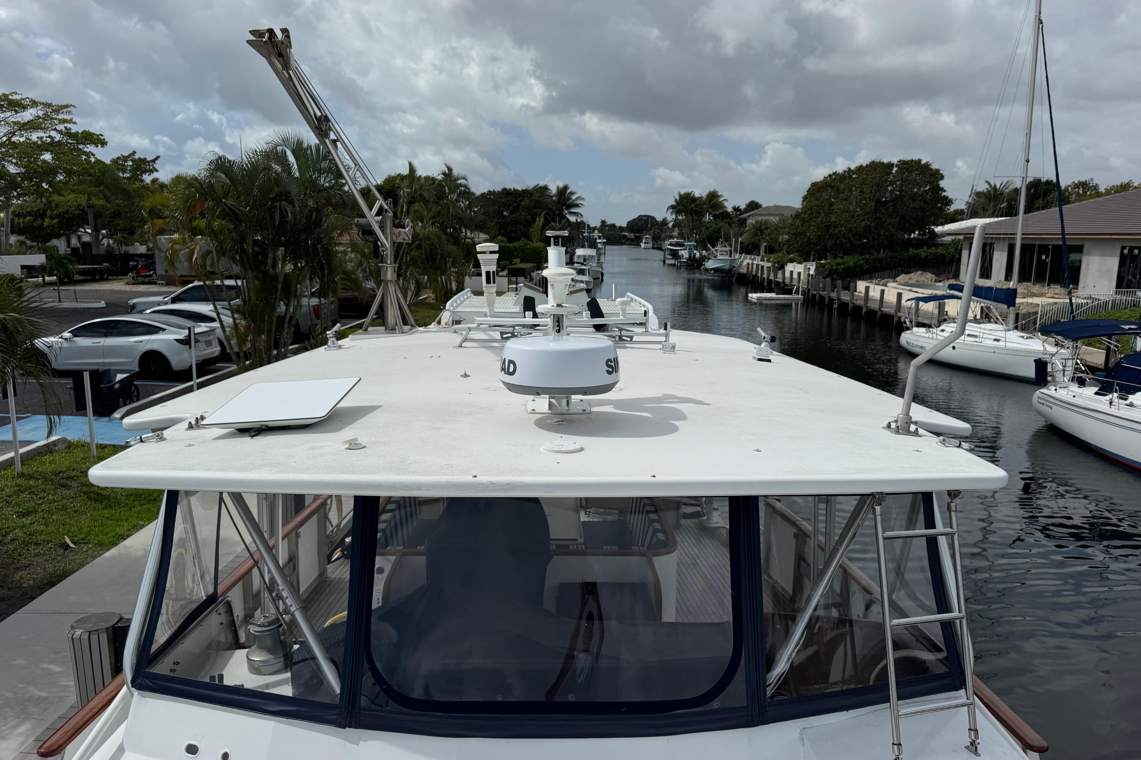 Custom 1982 Virpack Steel Hull boat docked in a scenic canal with surrounding yachts.