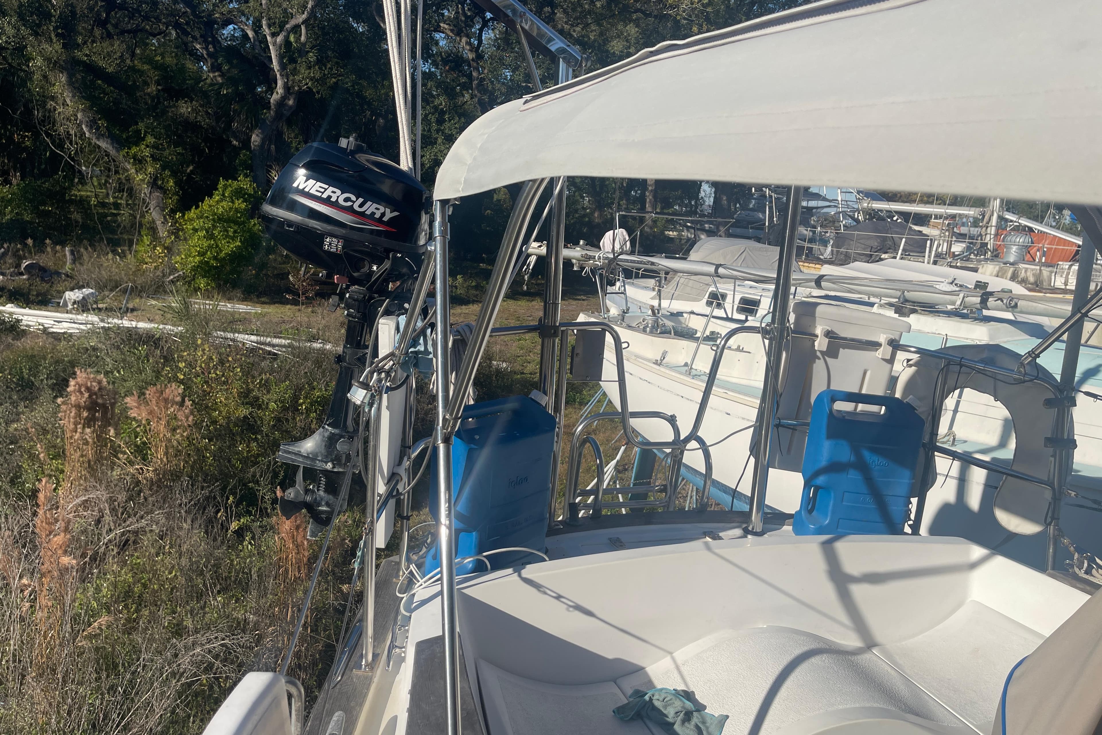 1984 Morgan 384 sailboat with Mercury outboard motor, docked in a marina.