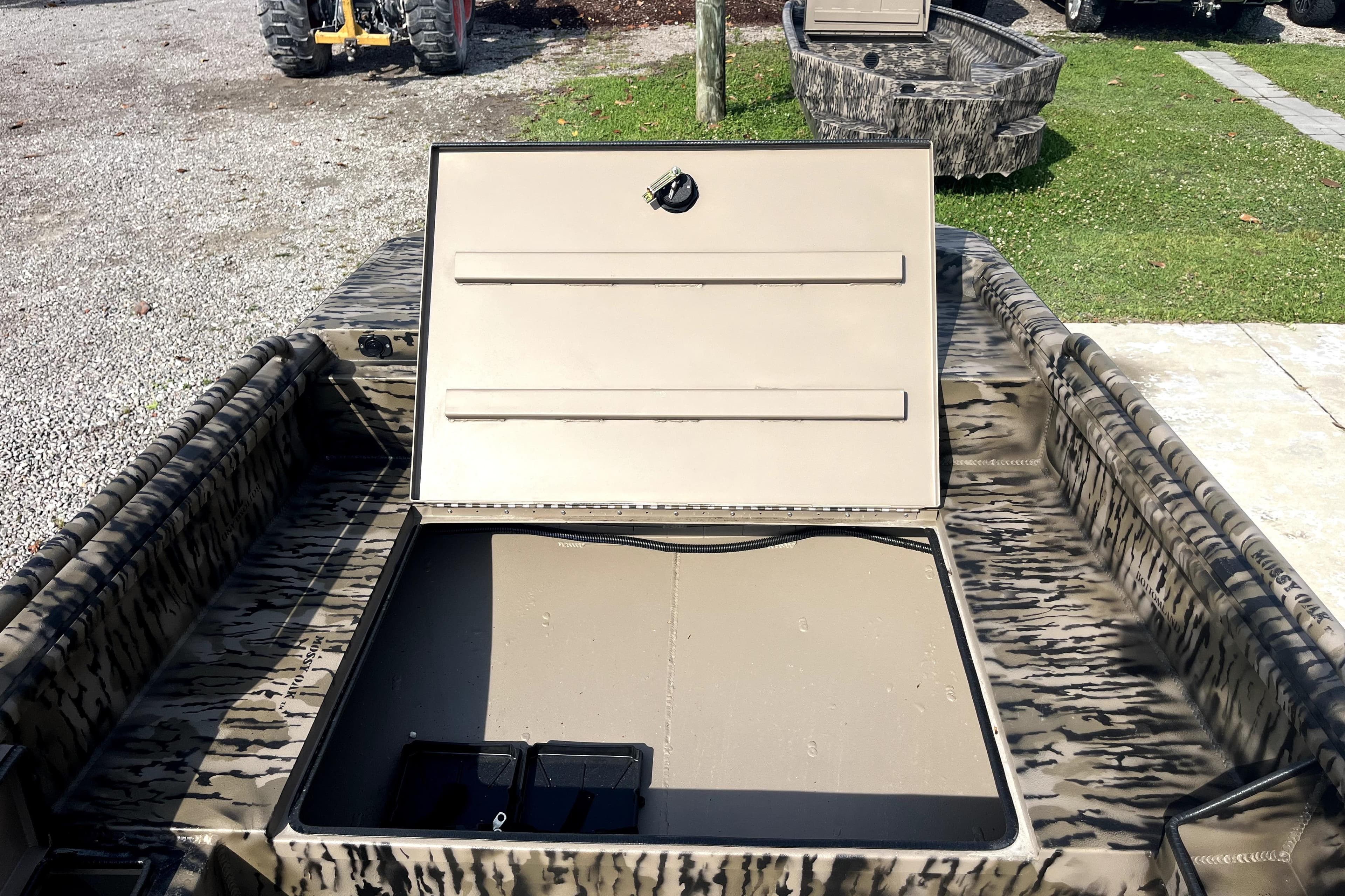 2026 Excel 1754 Shallow Water F4 Pro Hull with open storage compartment, camo design.