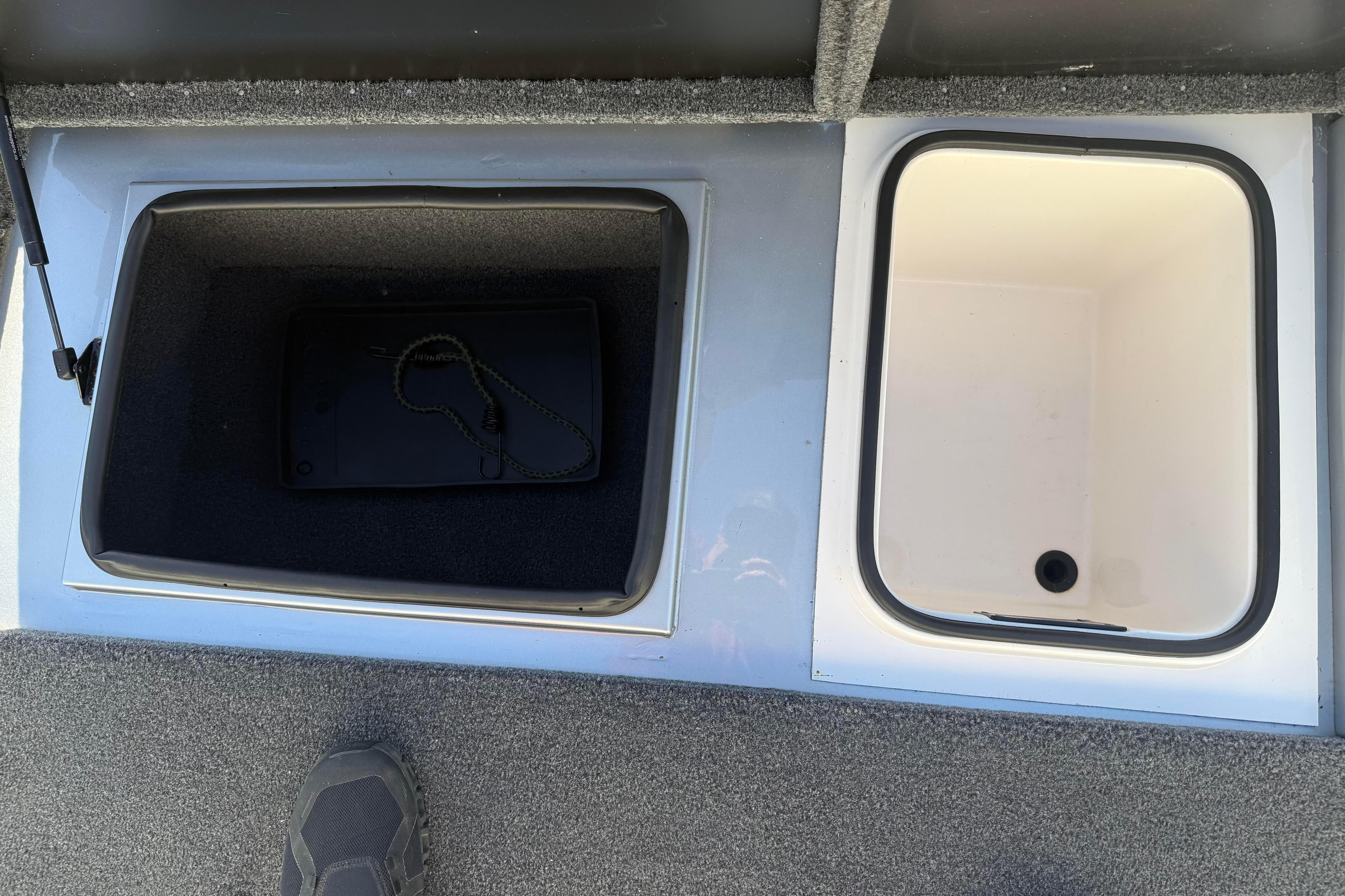 2024 Vexus AVX 1980 boat storage compartments, featuring carpeted and white interiors.