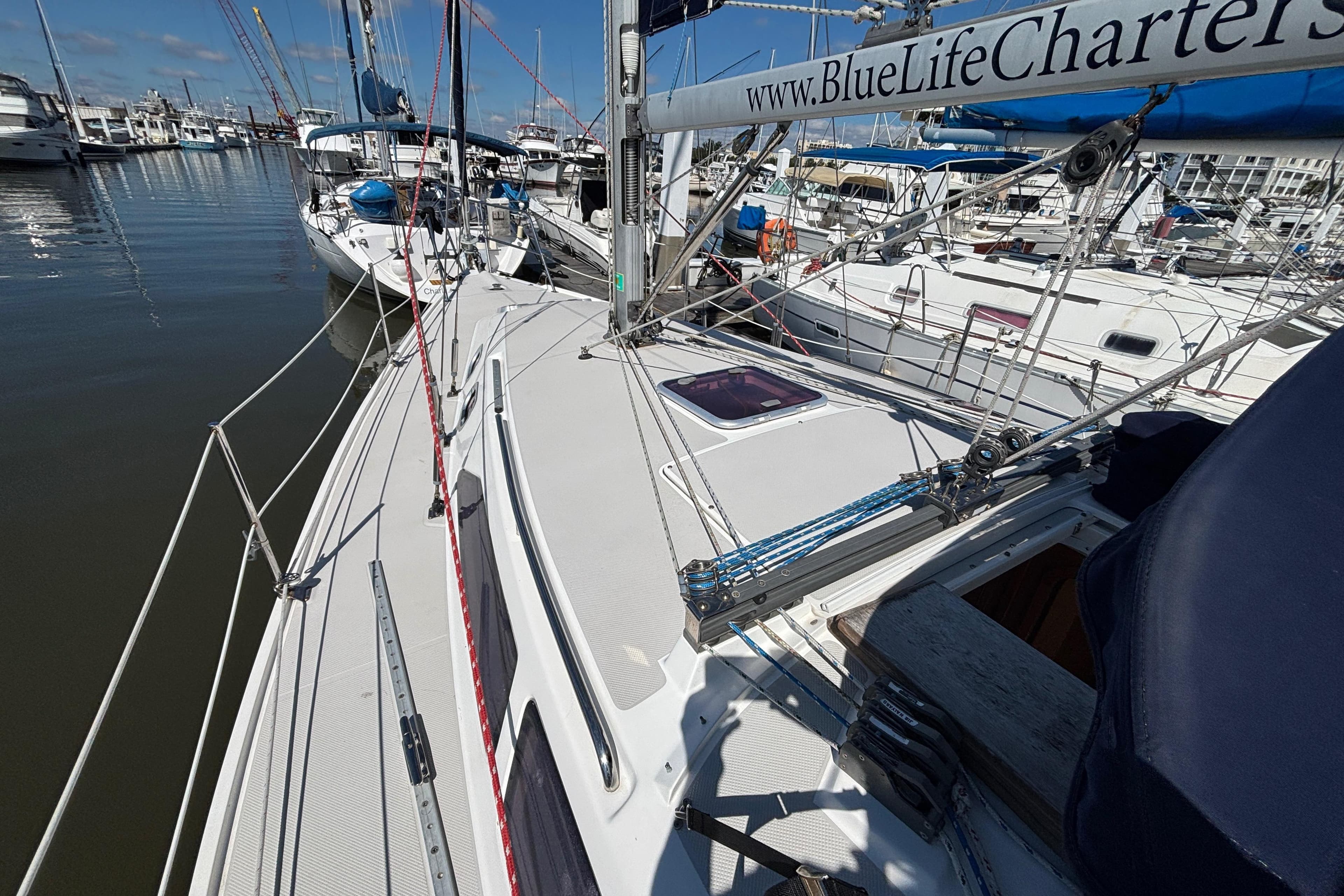2006 Catalina 320 sailboat docked at marina, featuring deck and rigging details.