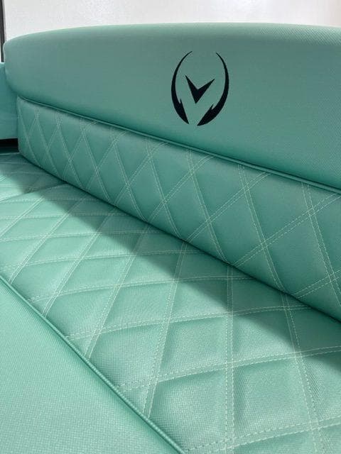 2023 Vision Marine Technologies Fantail 217 boat seat with quilted turquoise upholstery.
